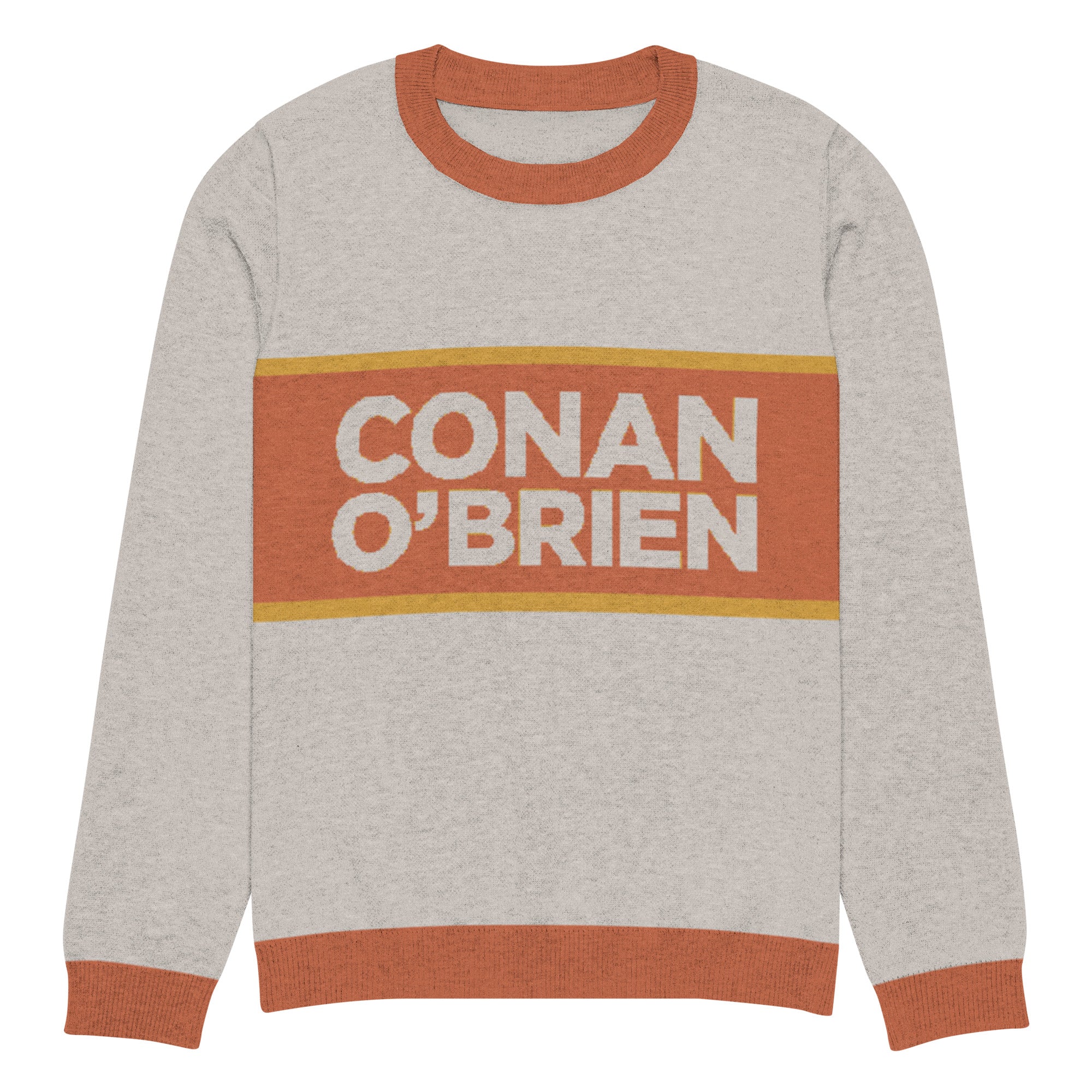 Sweater with 'CONAN O'BRIEN' printed in bold text on a sand background with an orange and yellow stripe.