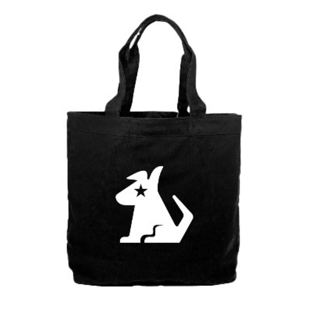 A black tote bag with a white graphic of the Stella Dog logo with a star over its eye. The bag has a simple yet bold design with sturdy black handles.