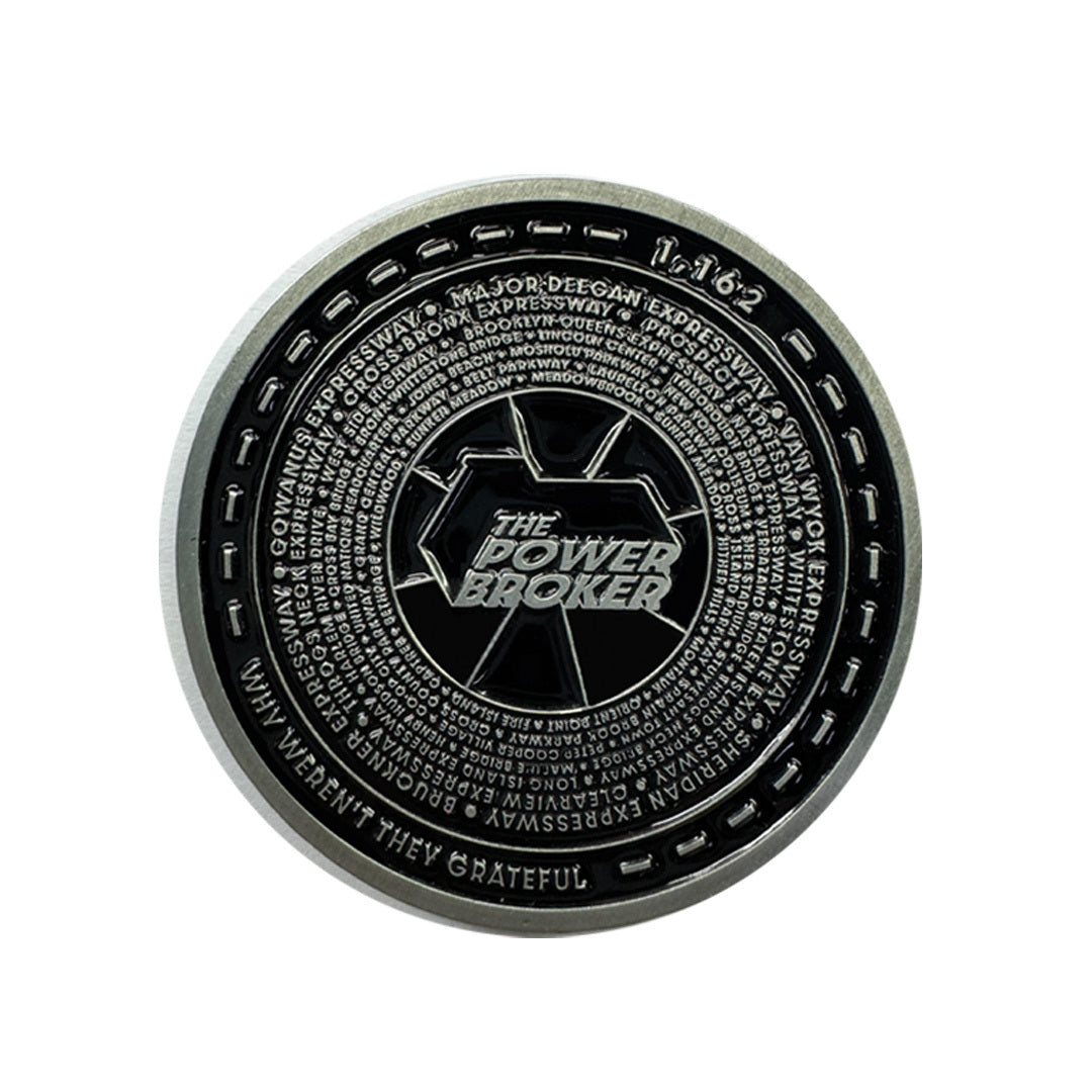 Round coin featuring the text 'THE POWER BROKER' in the center, surrounded by various smaller texts and designs.