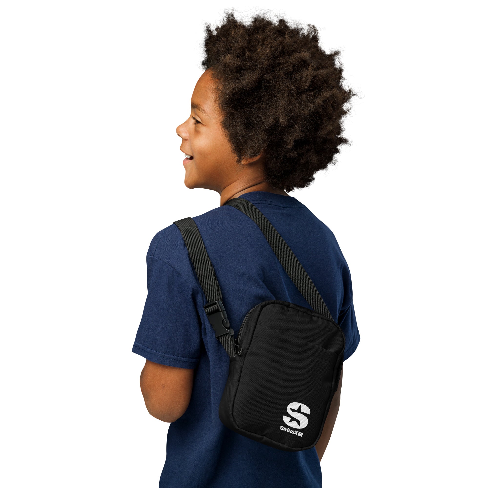 A child wearing a navy blue t-shirt and a 'SiriusXM' utility bag slung over his shoulder. The black bag features the 'SiriusXM' 'S' logo in white and has an adjustable strap for a comfortable fit.