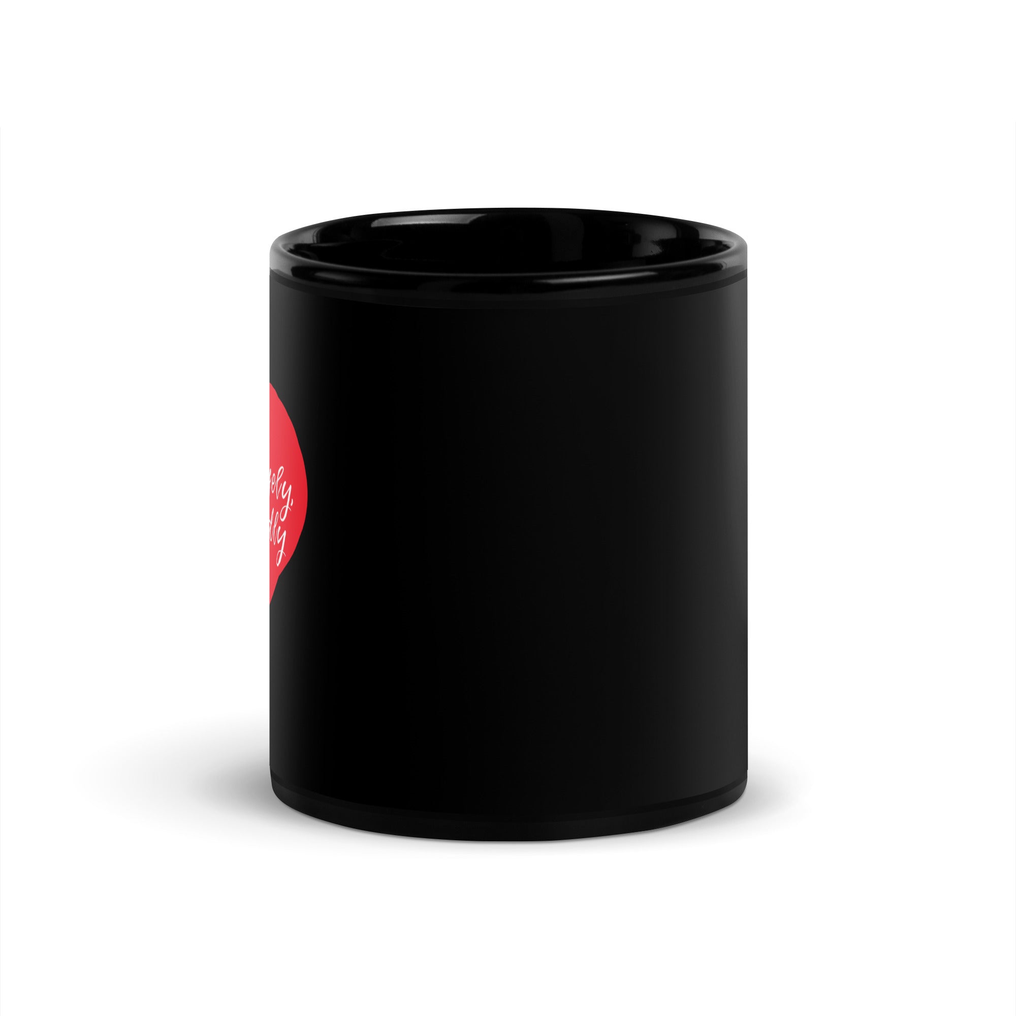 Side view of black glossy mug with partially visible red heart and white cursive text.