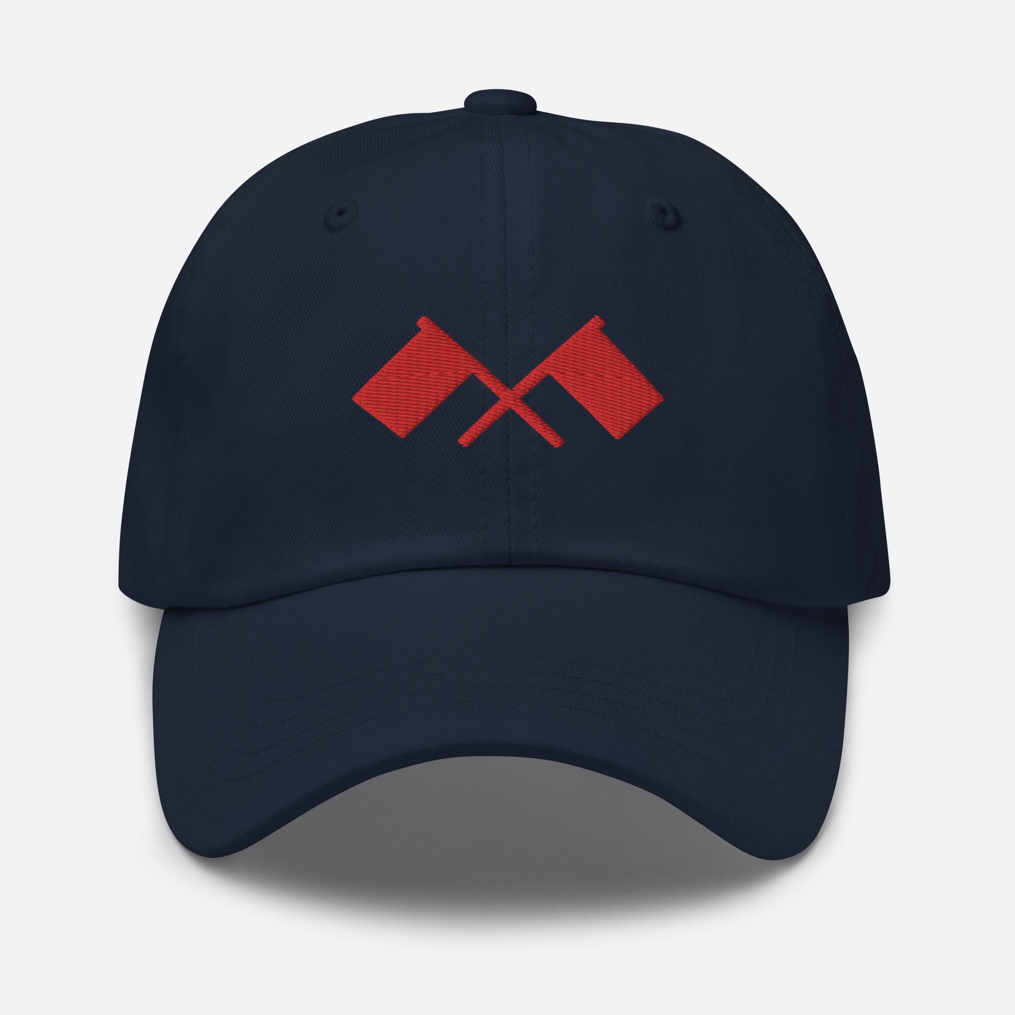 Front of navy blue baseball cap featuring a design of two red crossed flags.