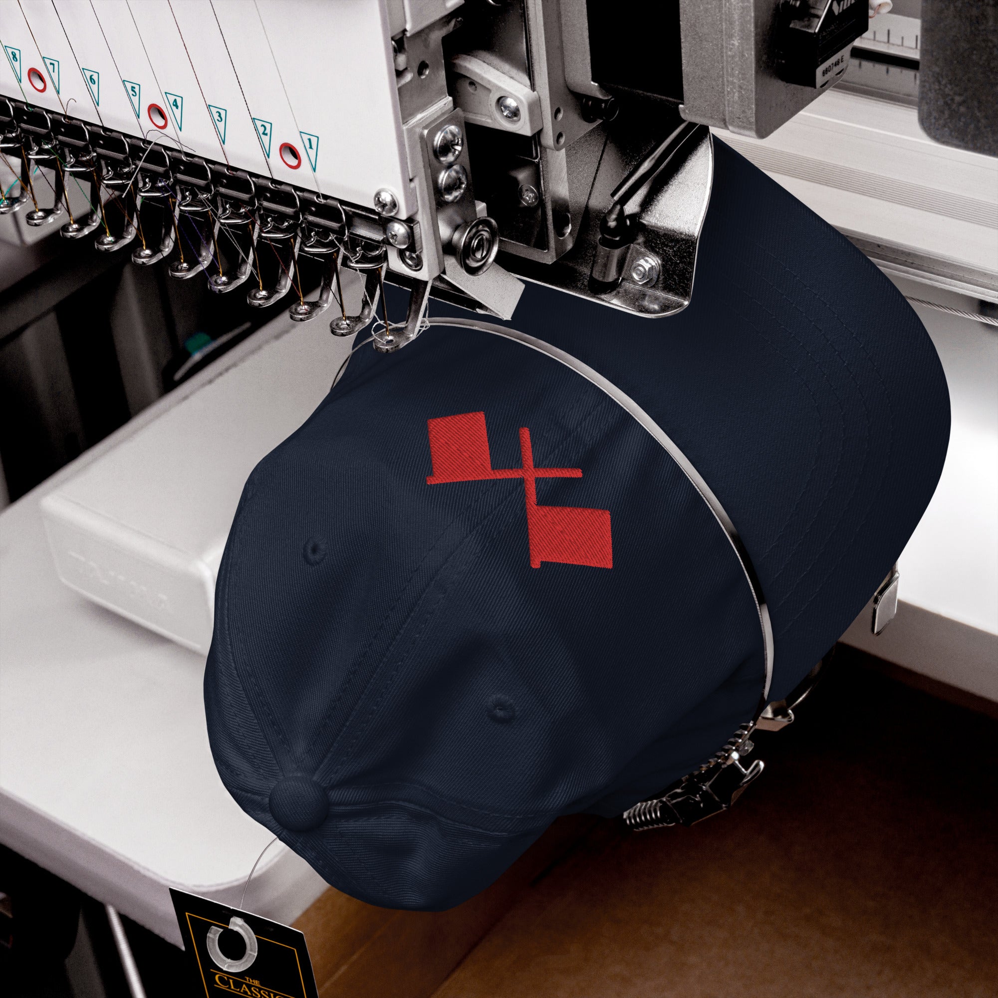 Navy blue baseball cap with two red flags, crossed on front.