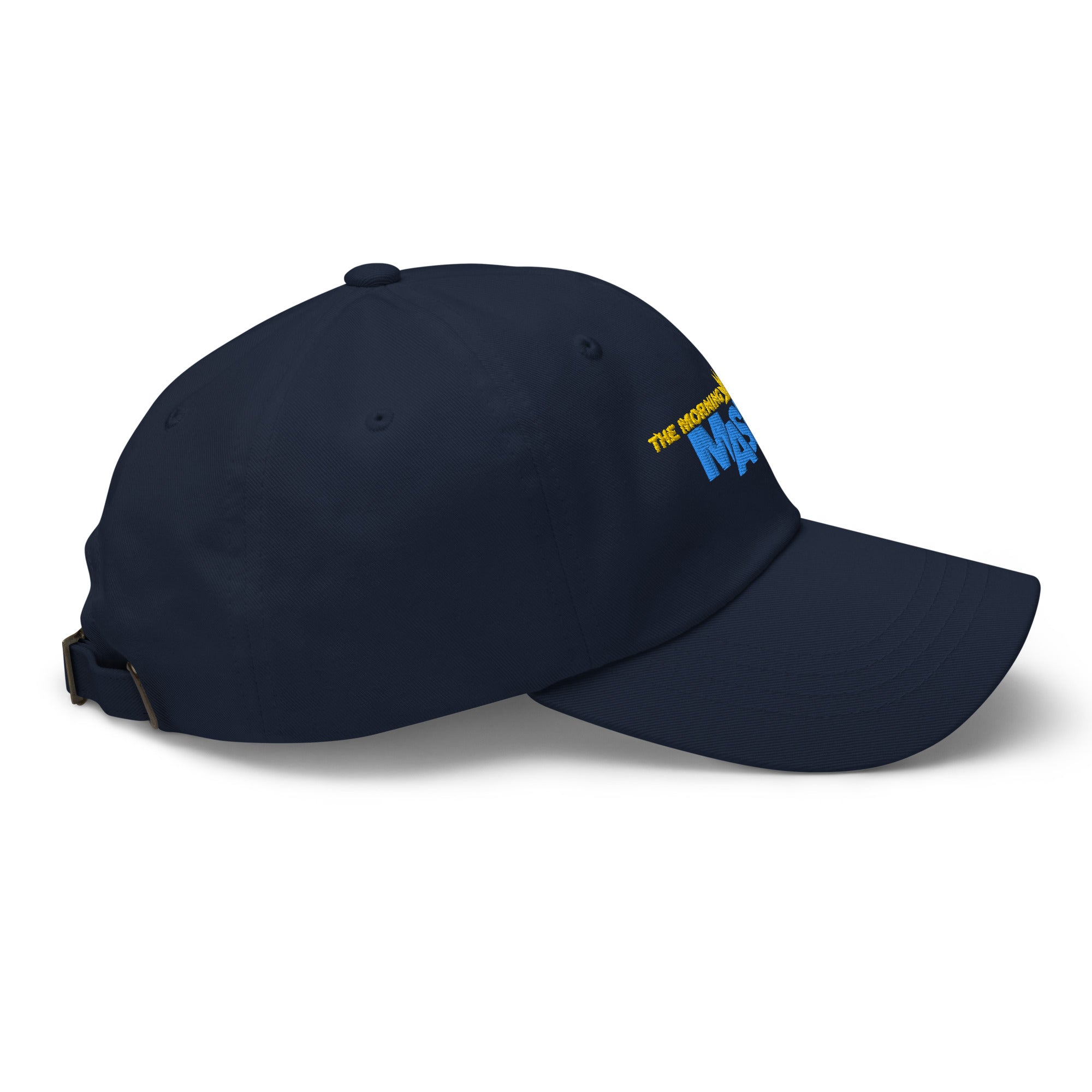 A navy blue baseball cap featuring the embroidered text 'THE MORNING MASHUP' with a sun and steaming coffee graphic.