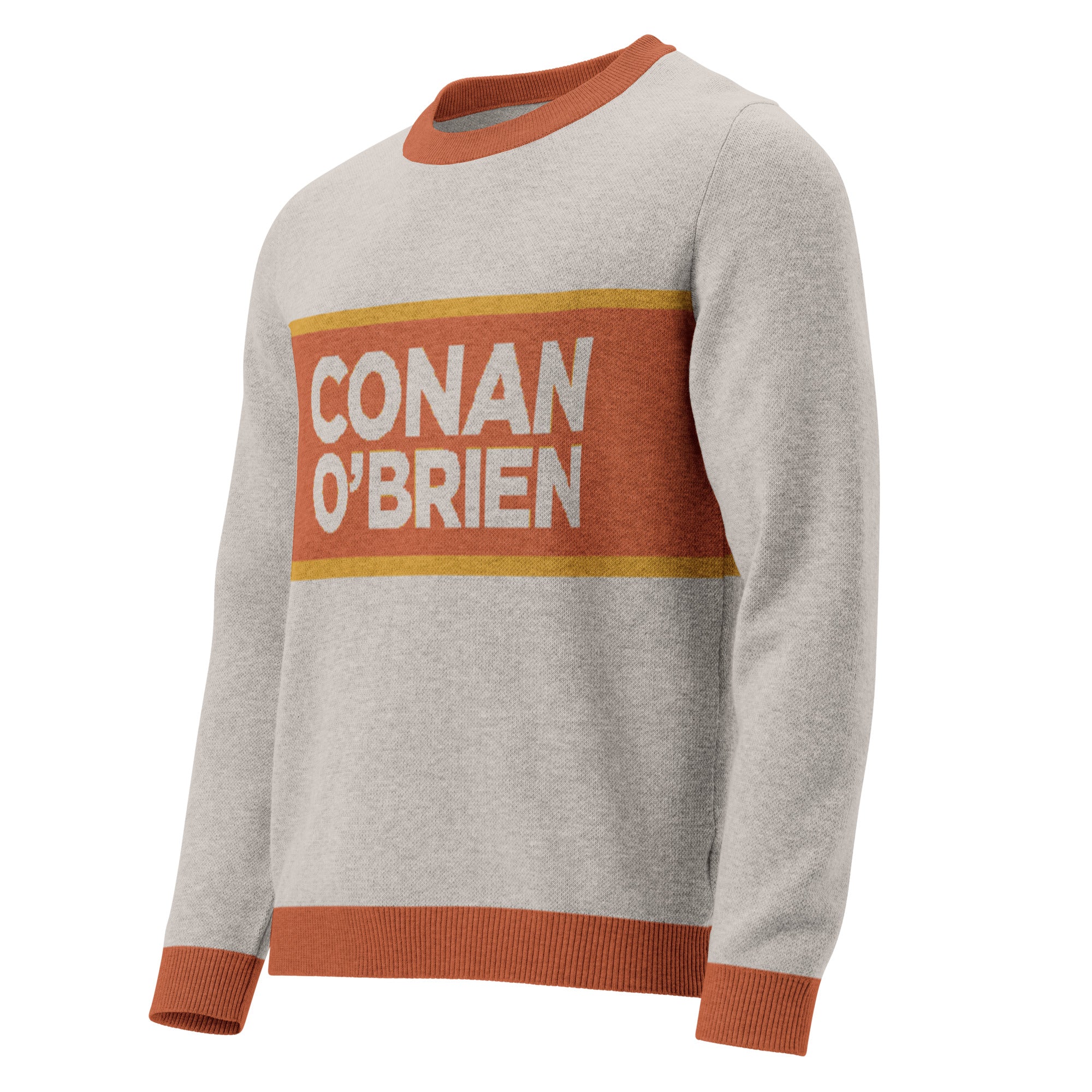 Side view of sand colored sweater featuring 'CONAN O'BRIEN' text against an orange stripe with a yellow border.