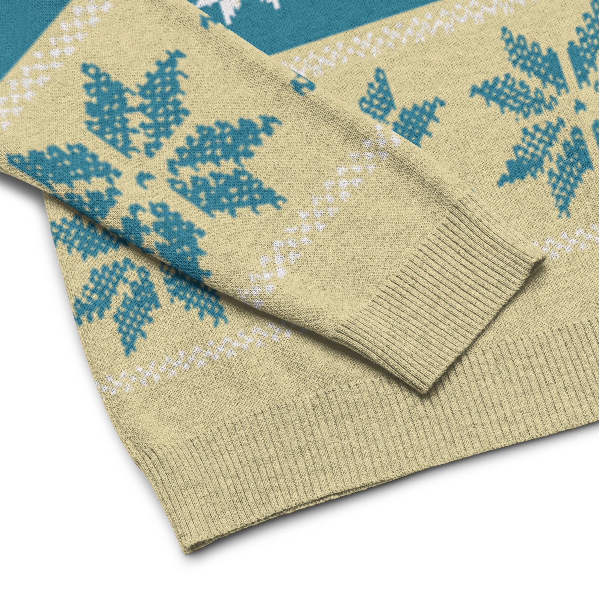 A close-up of a textured sweater featuring a light yellow base with a blue and white snowflake pattern.