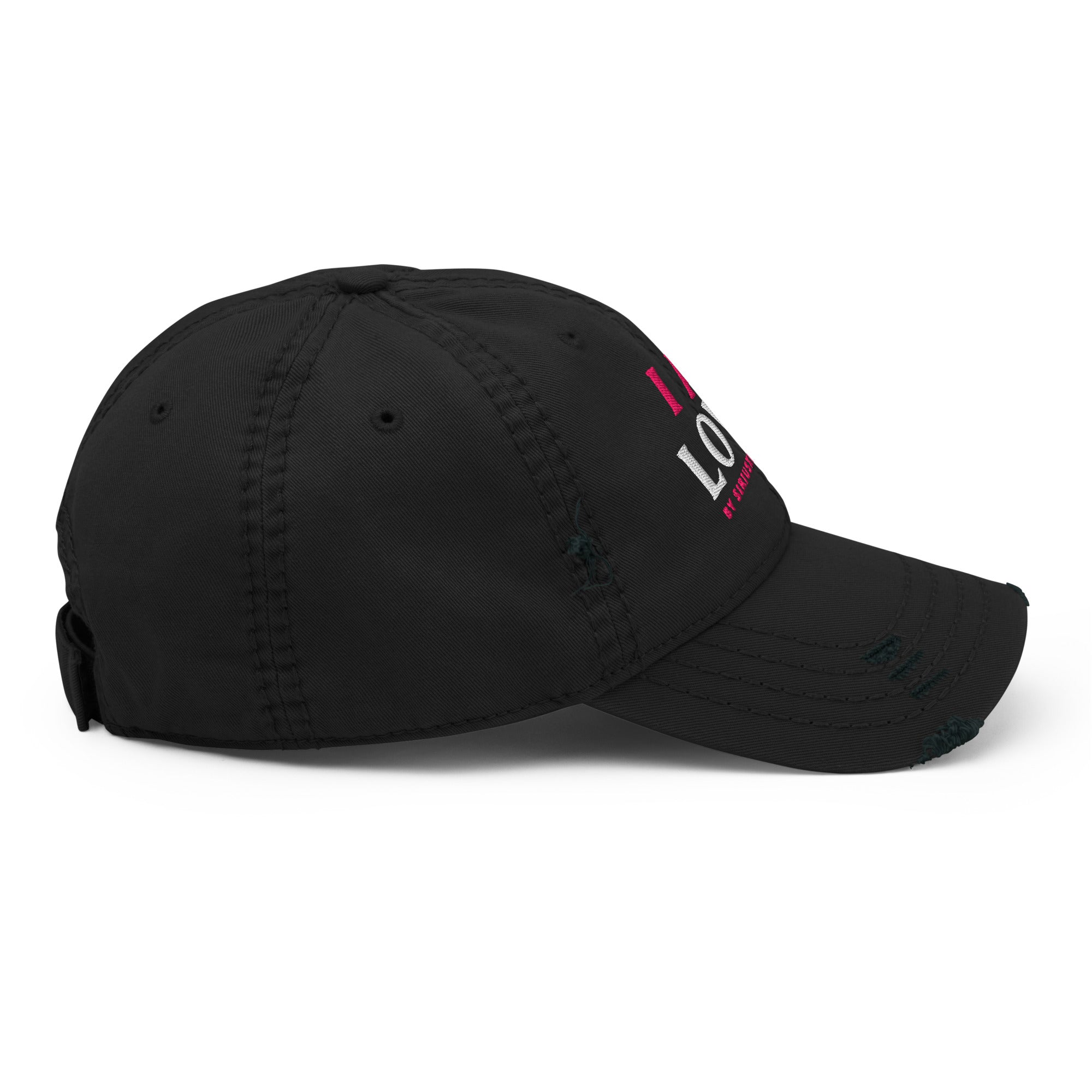 The right side profile view of black baseball cap with partially visible pink and white text.