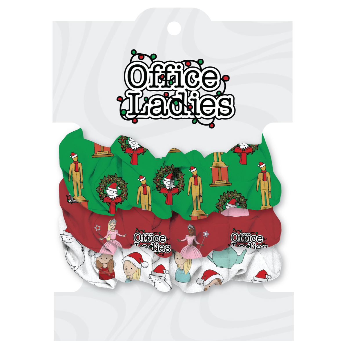 A collection of three scrunchies featuring festive designs, including Christmas motifs and characters, with packaging labeled 'Office Ladies.'  Scrunchie colors are green, red, and white.