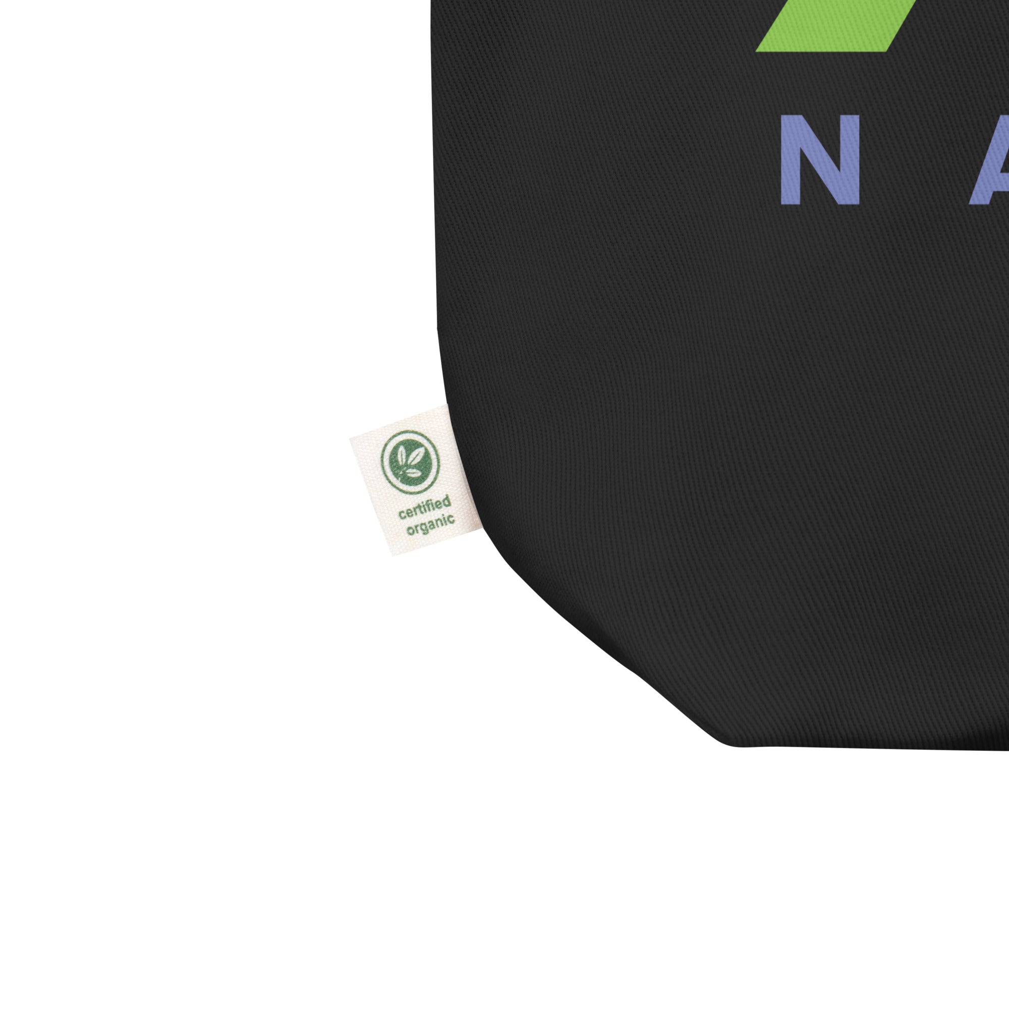 Close up of black tote bag corner with tag stating 'Certified Organic'.