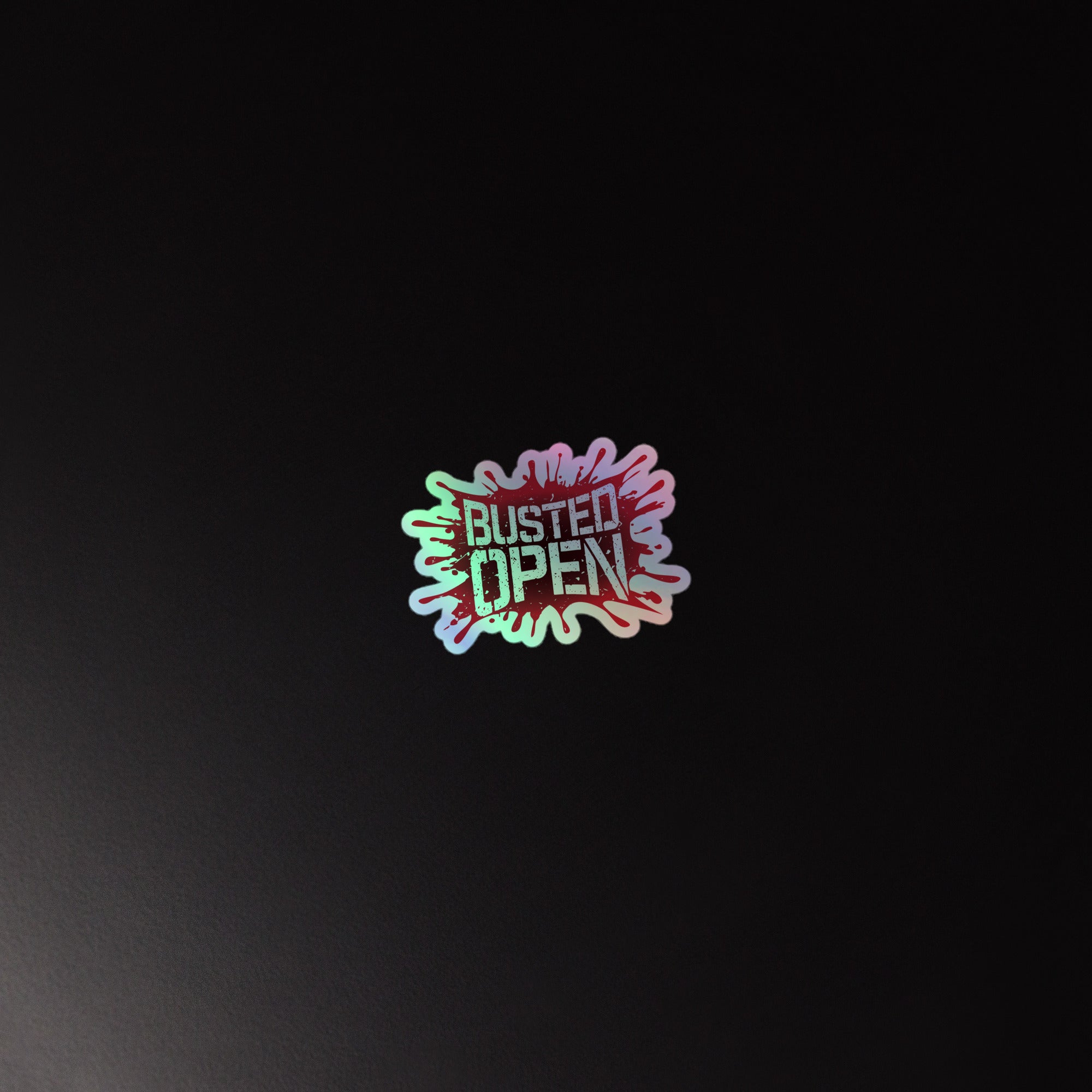 Holographic sticker with the text 'BUSTED OPEN' in a splash design on a black background.