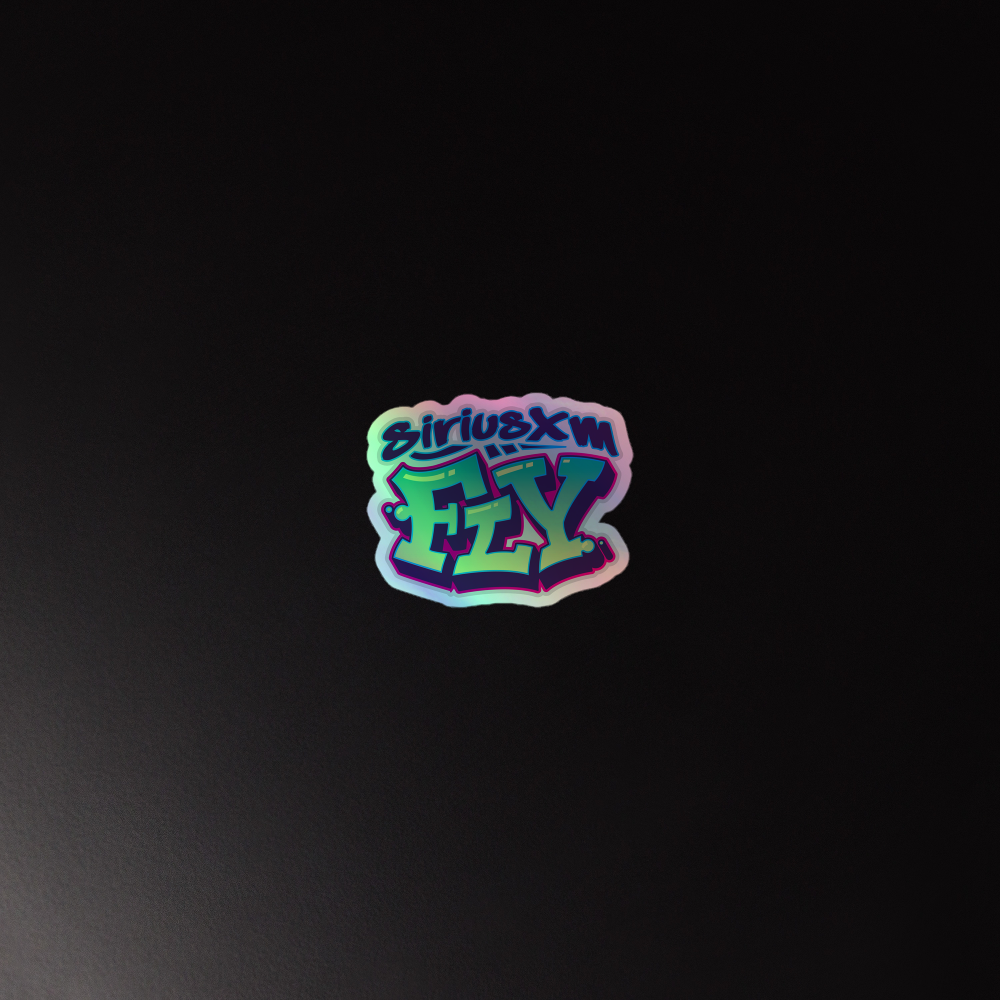 Holographic sticker of the 'SiriusXM FLY' logo featuring a colorful, graffiti-style font on a black background.