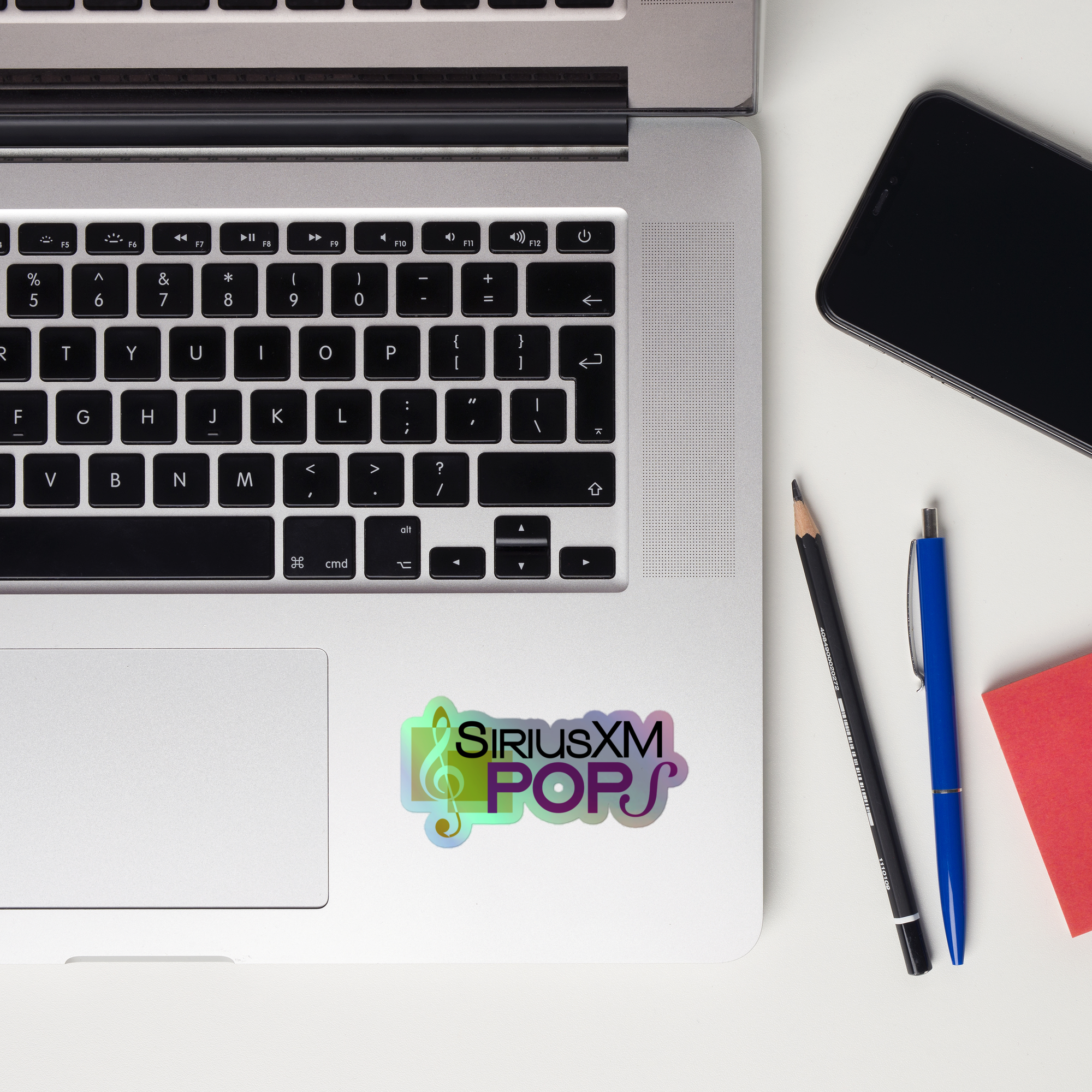 Laptop keyboard displaying a 'SiriusXM Pops' holographic sticker.