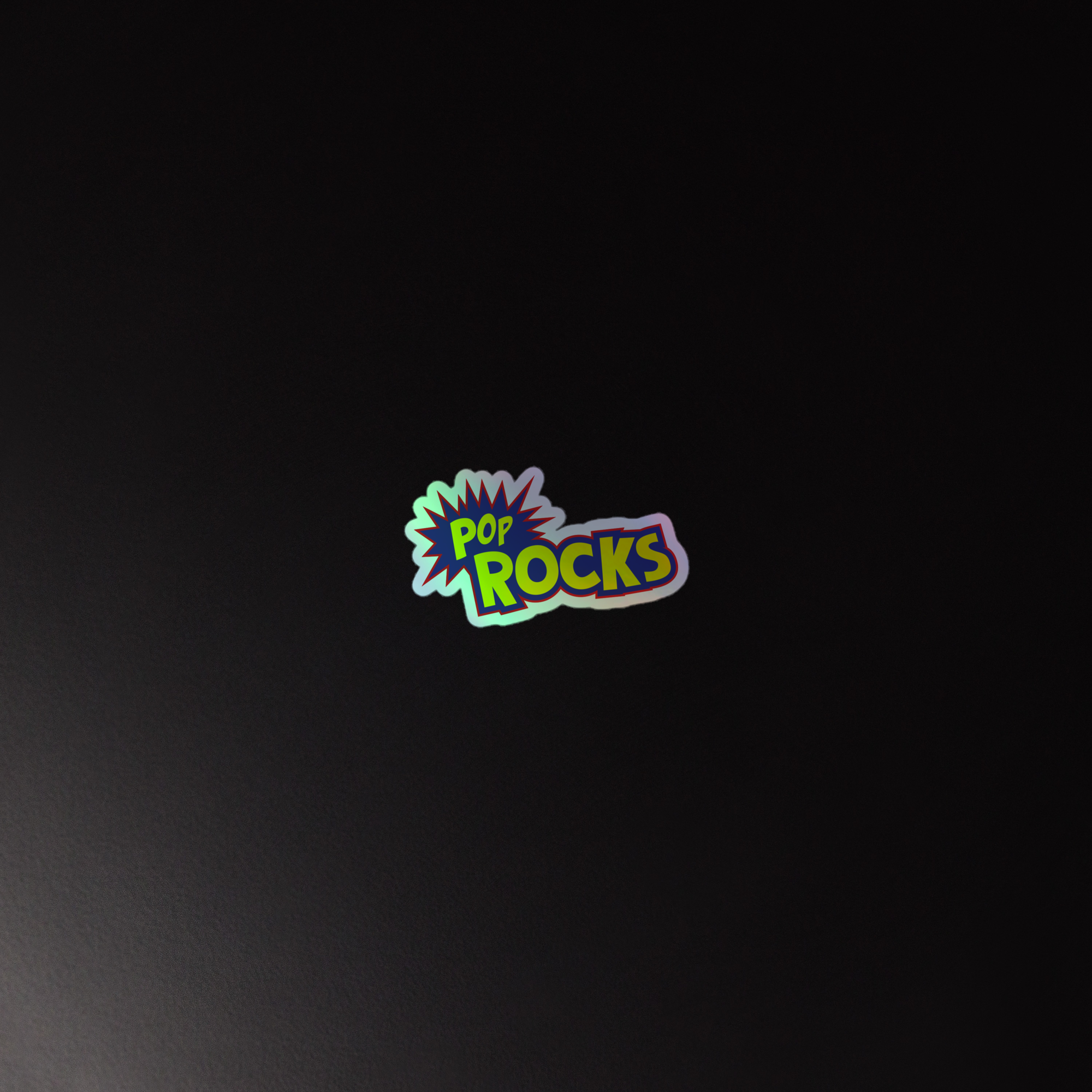 Colorful 'POP ROCKS' logo holographic sticker on a dark background.