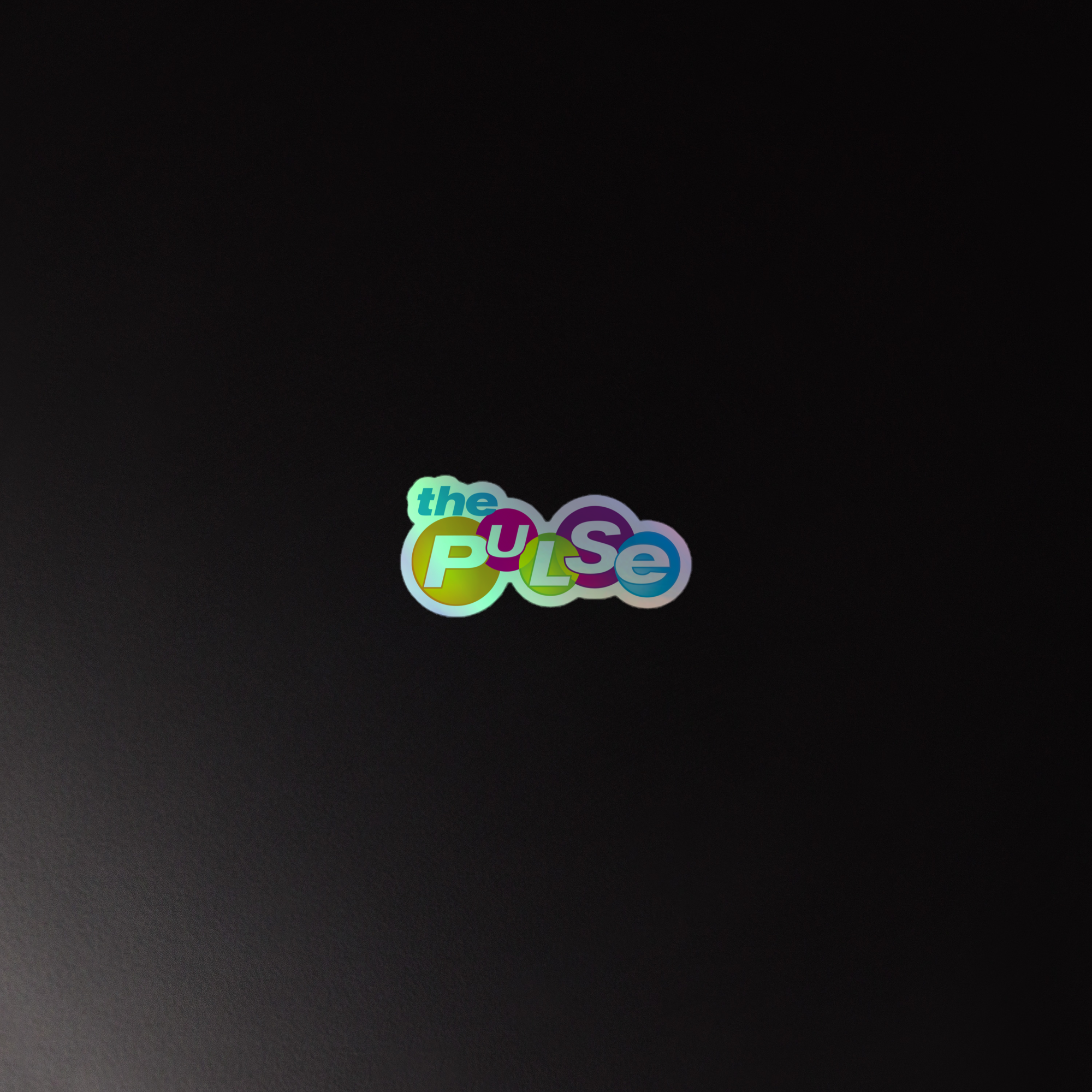 Colorful holographic sticker of the 'the PULSE' logo on a dark background.