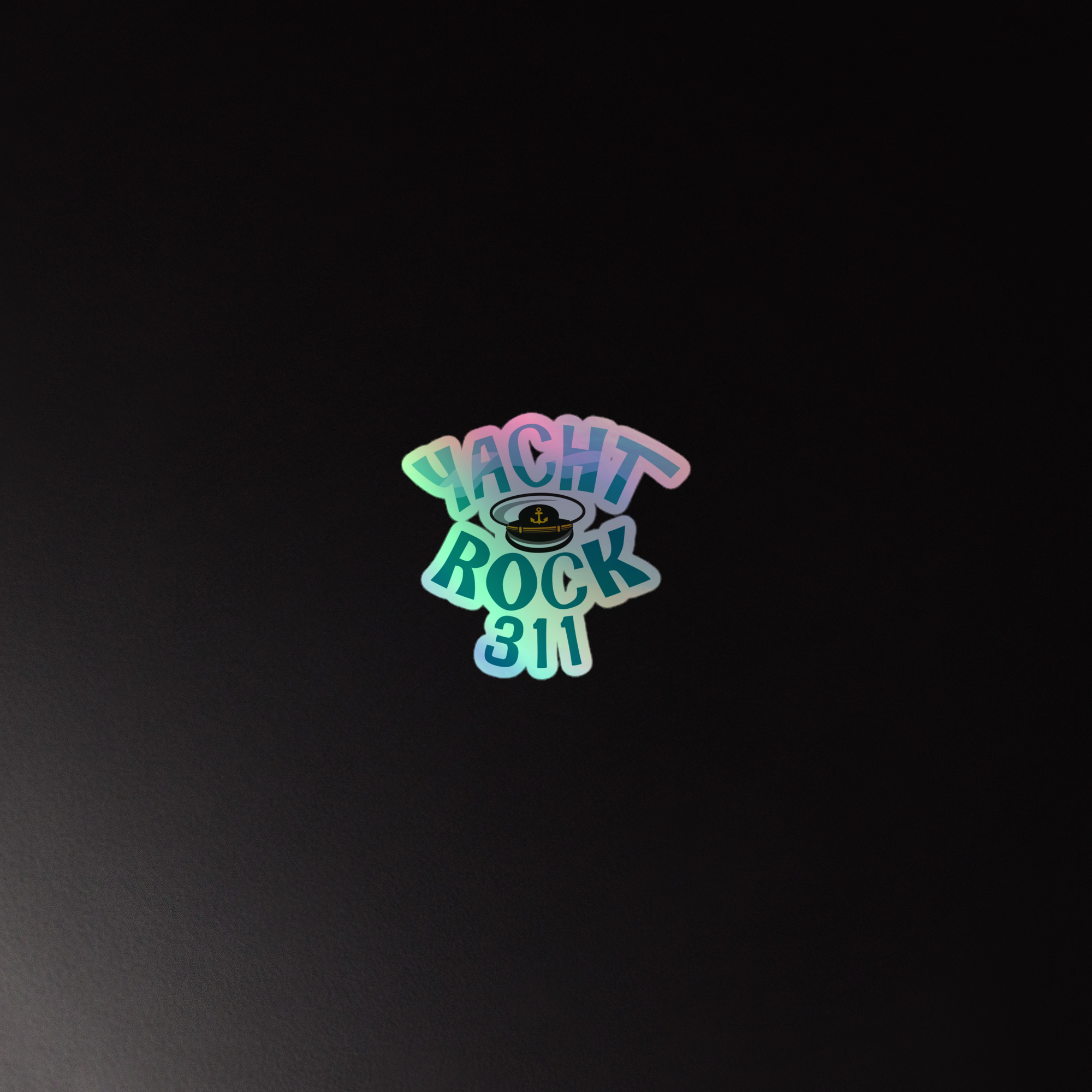 Colorful holographic sticker featuring the text 'Yacht Rock 311' with a captain's hat graphic on a black background.