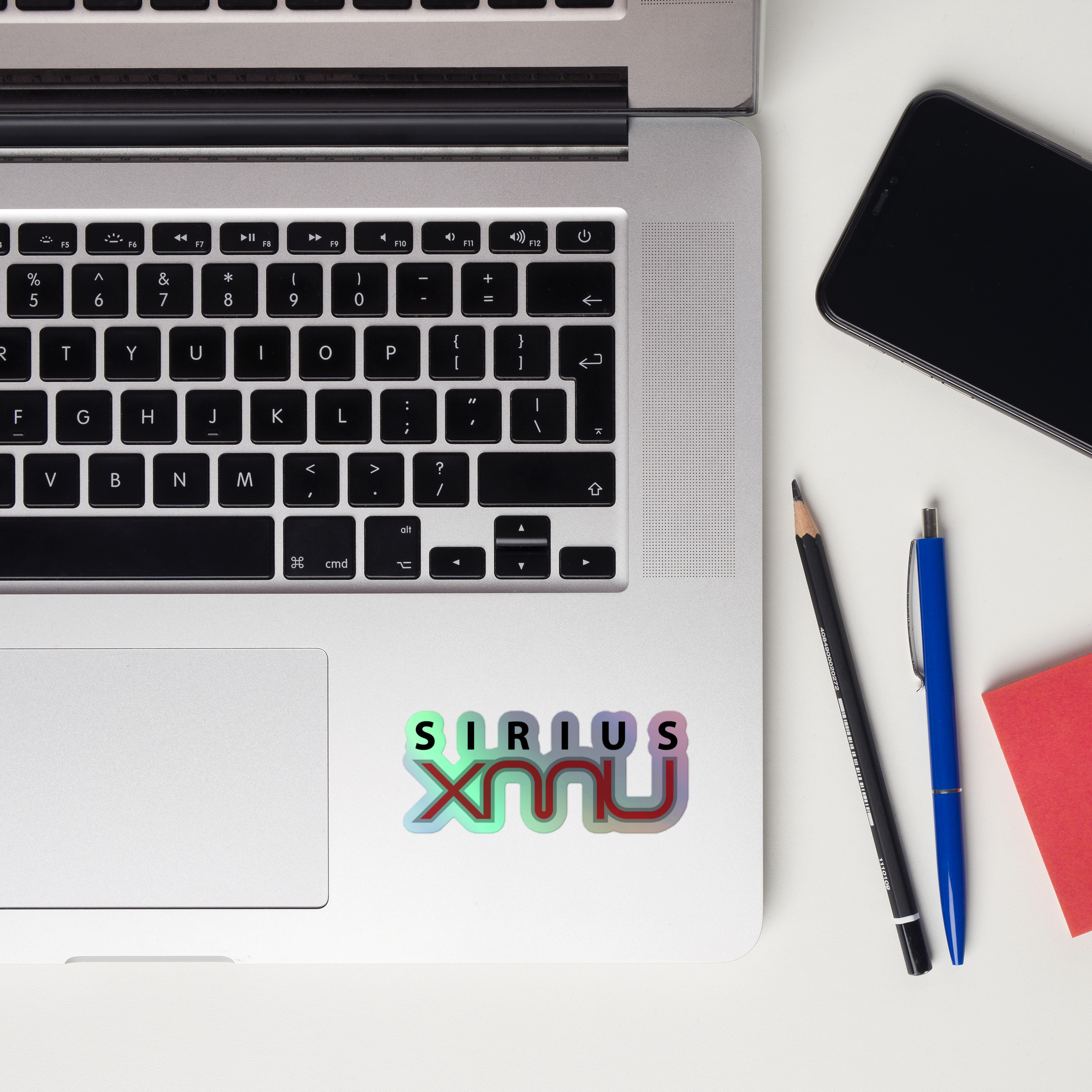 Laptop keyboard displaying a 'SiriusXMU' holographic sticker.