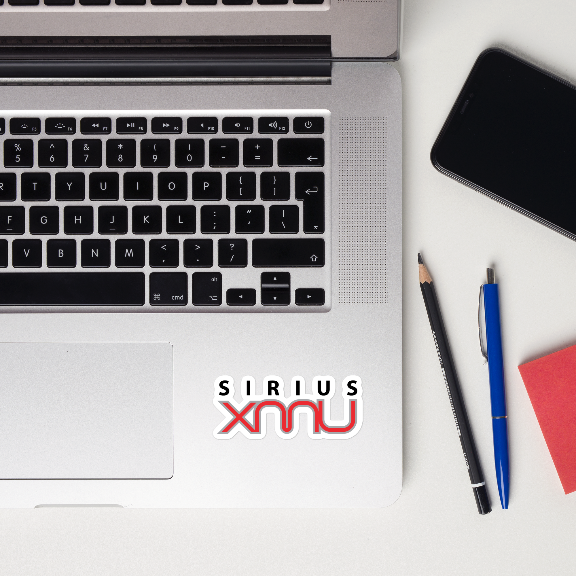 A laptop keyboard displaying a 'Sirius XMU' sticker.