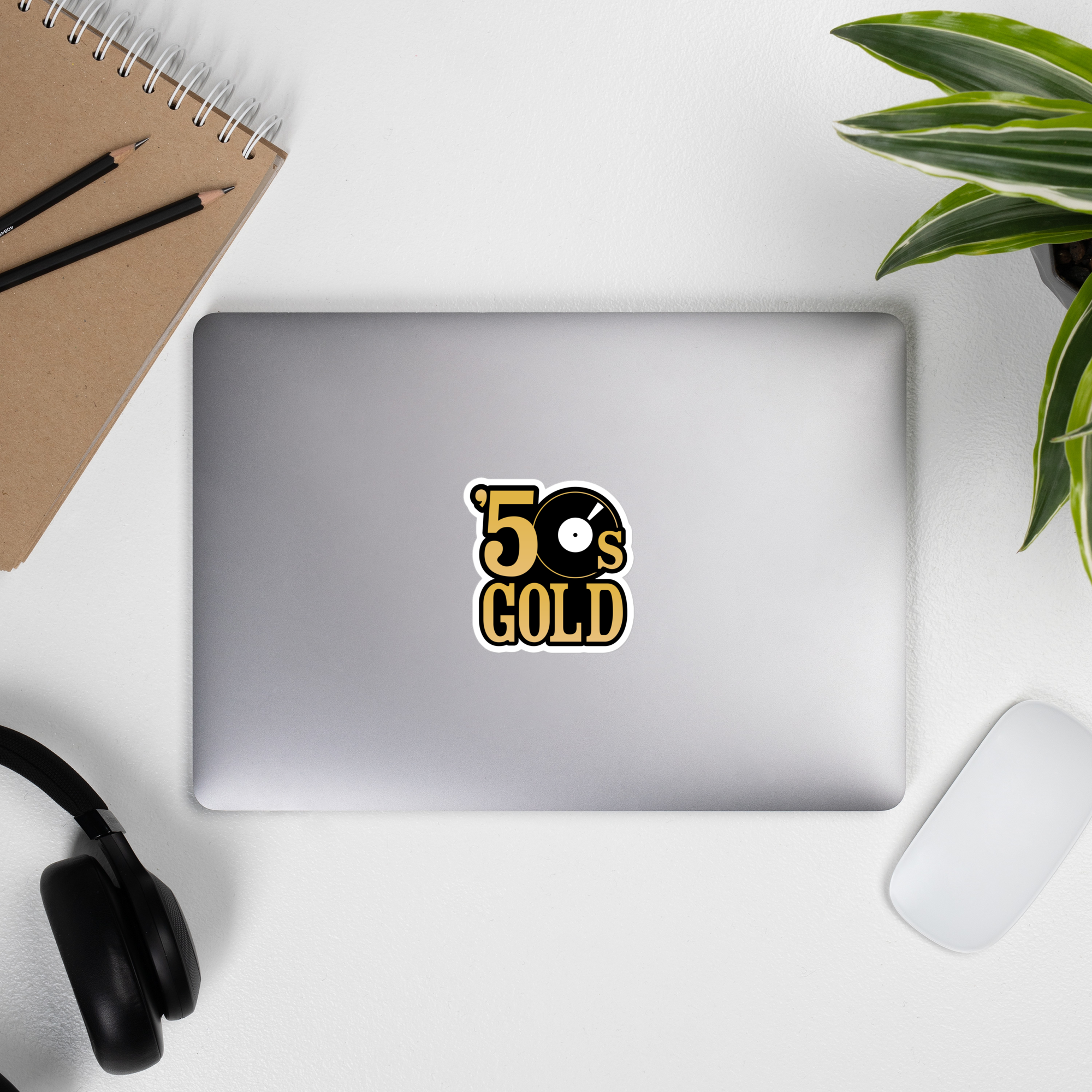 A laptop displaying a '50s Gold' sticker.