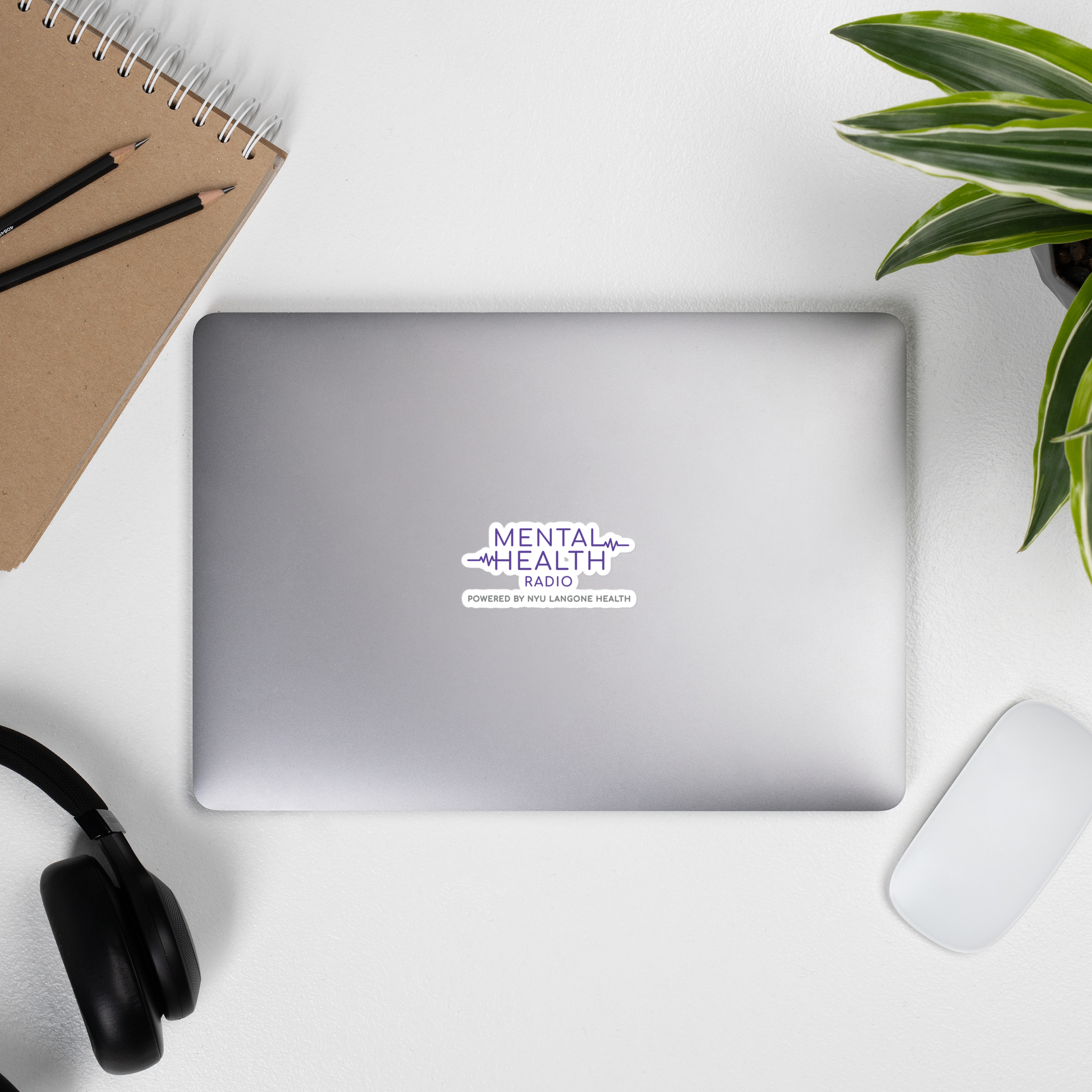 Laptop displaying a 'Mental Health Radio' sticker.