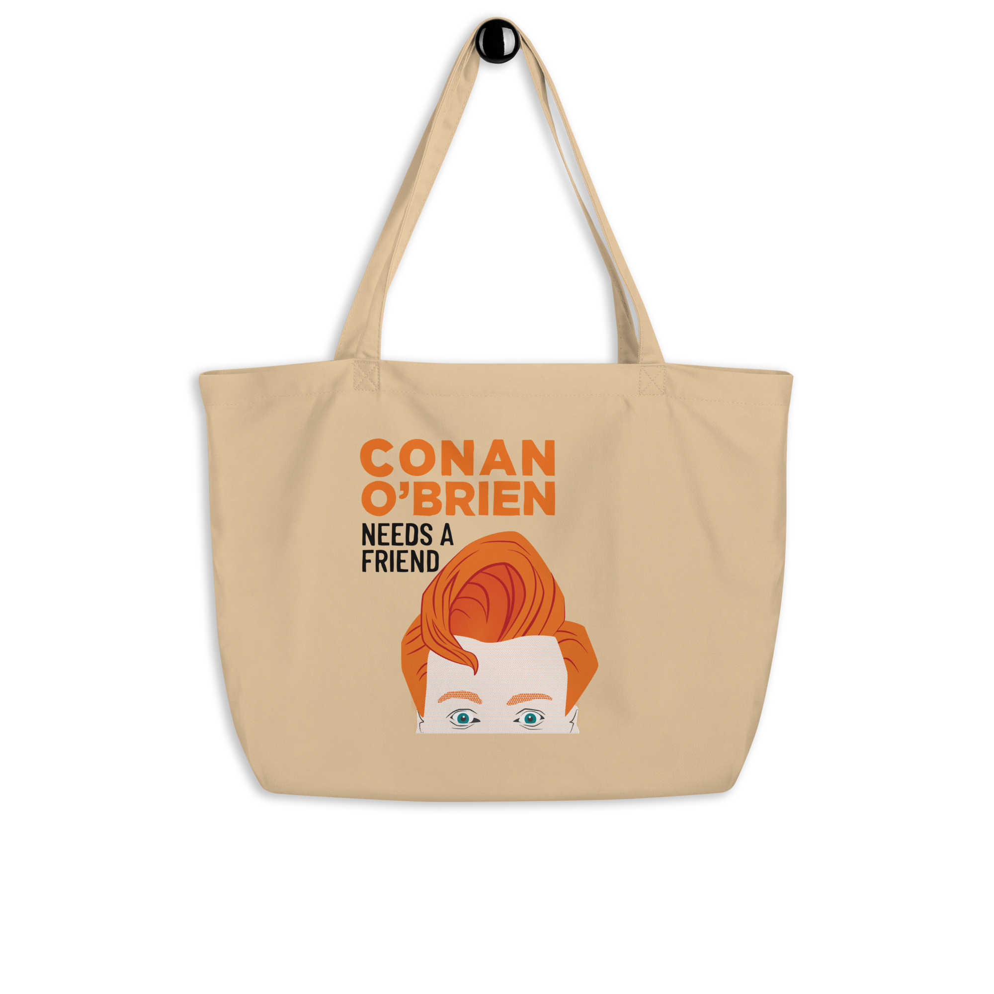 Cream tote bag featuring a cartoon of a man with red hair and the text 'CONAN O'BRIEN NEEDS A FRIEND' on a black background.