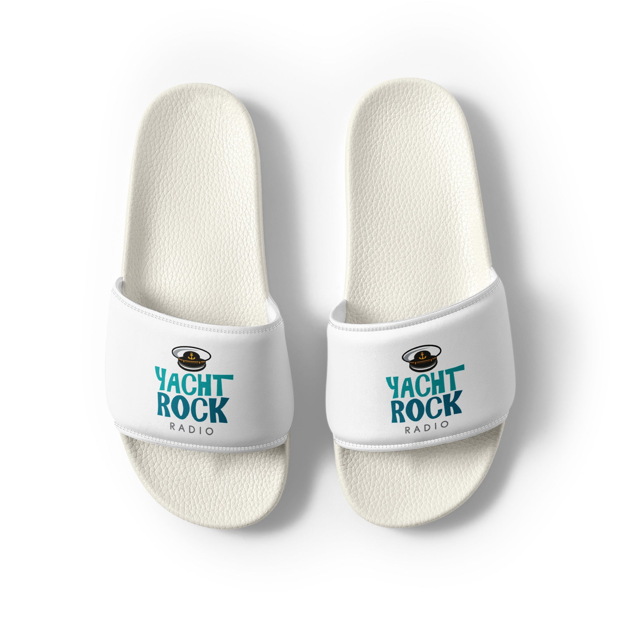 White slide sandals with 'Yacht Rock Radio' logo in teal with captain's hat graphic.