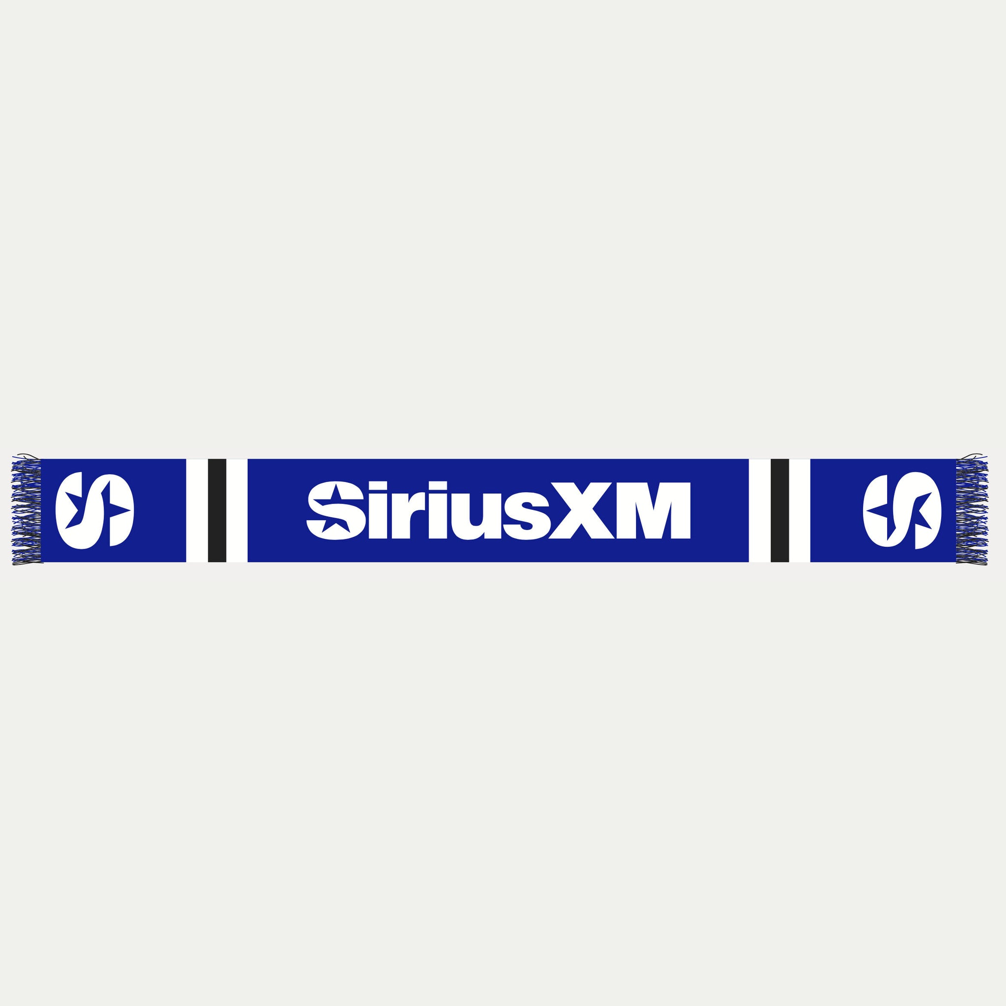 A blue 'SiriusXM' knit scarf featuring the 'SiriusXM' logo in white across the center. The scarf has black and white stripe accents near the edges and the 'SiriusXM' 'S' logo on both ends. The ends of the scarf are finished with blue fringe.