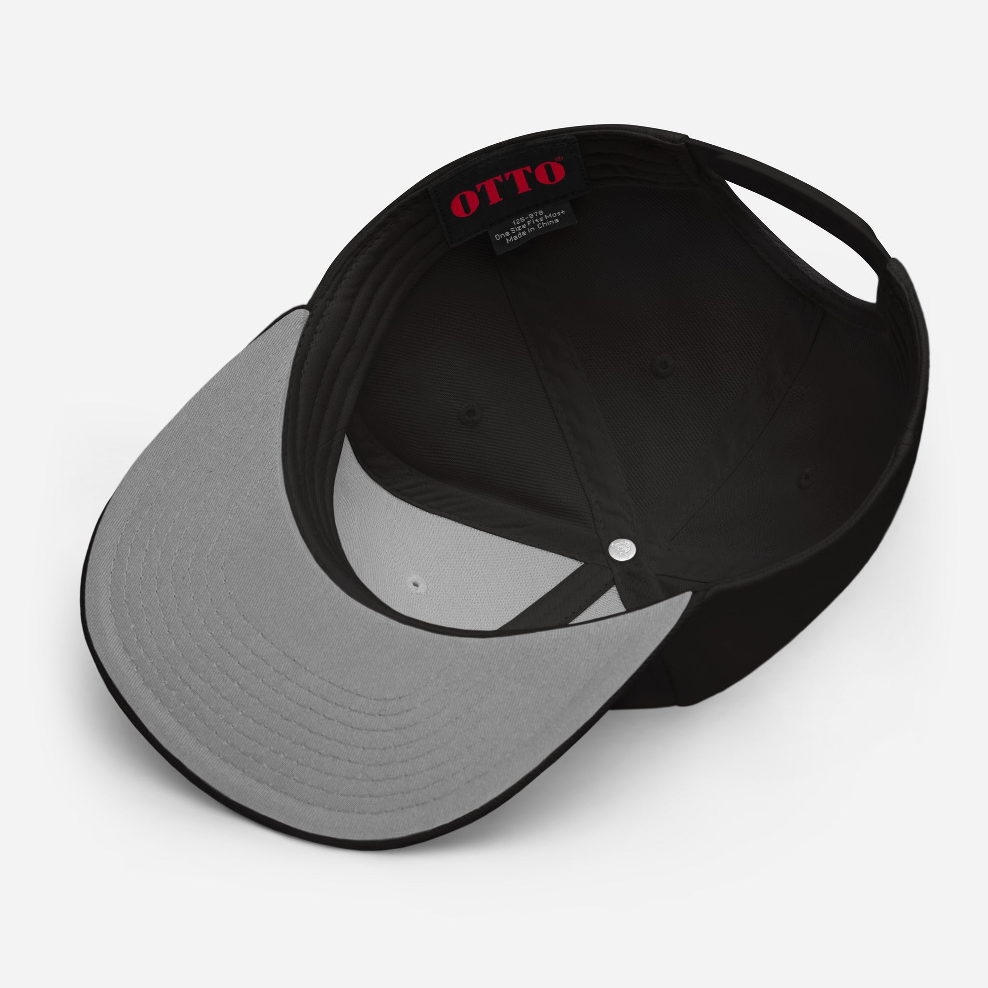 Black cap with a gray brim, view from below showing the interior and the label that reads 'OTTO' and a tag that says 'One size fits most. Made in China'