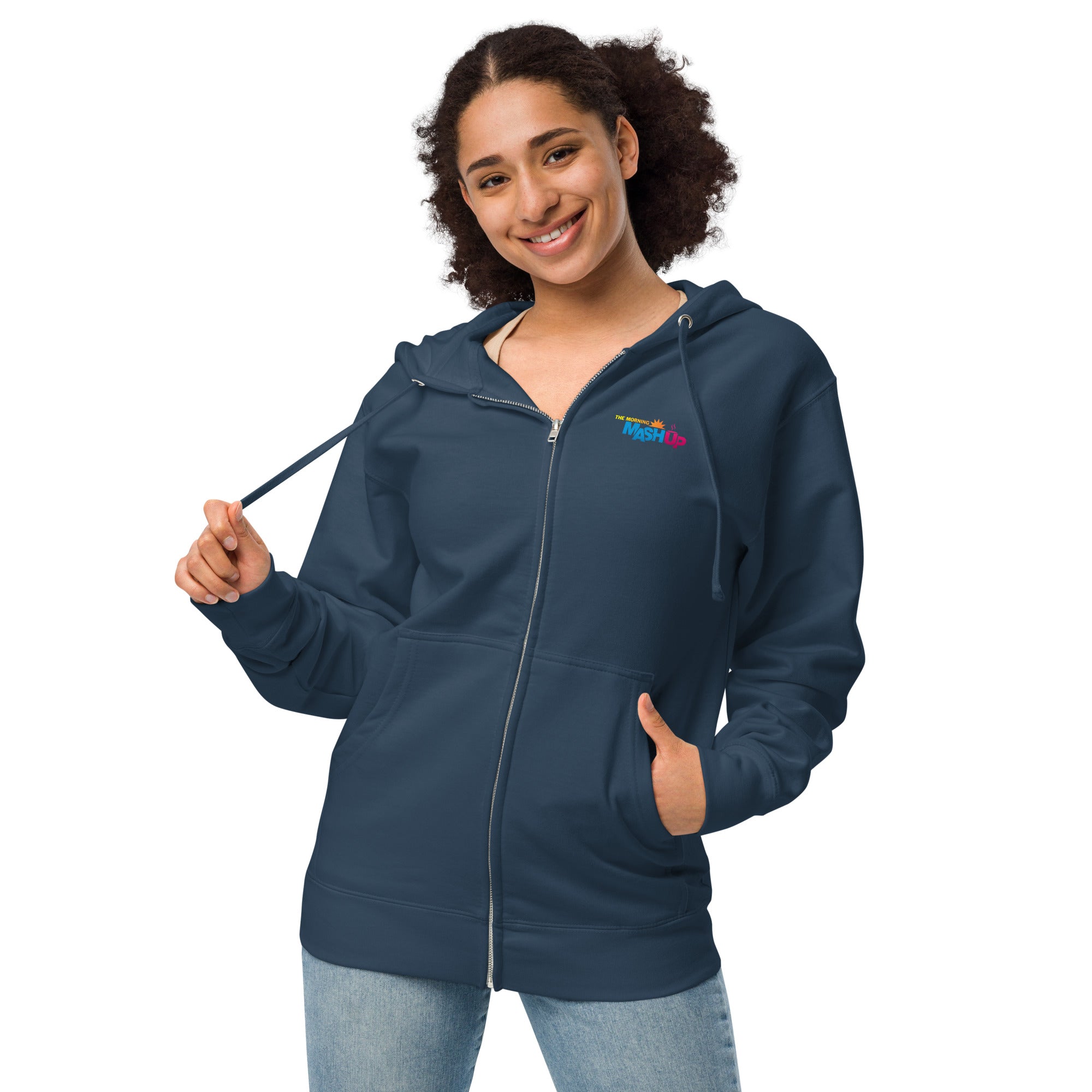 A smiling young woman wearing a navy blue zip-up hoodie with a colorful 'Morning Mash Up' logo on the chest, holding the hoodie strings.