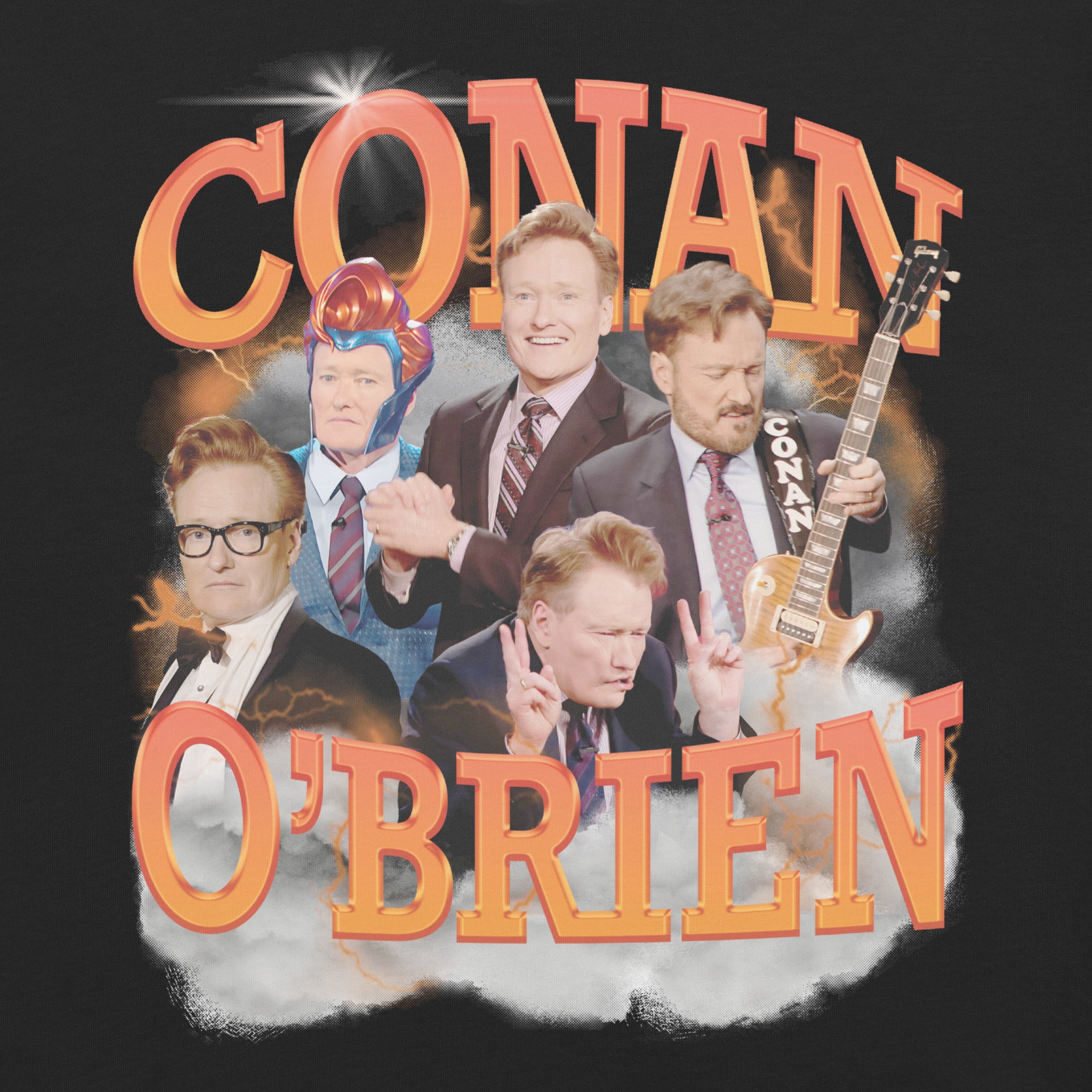 A close-up of the Conan O'Brien graphic design on the black t-shirt, showing detailed images of Conan in different poses with bold, orange 3D lettering that reads 'CONAN O'BRIEN,' surrounded by a cloudy and lightning-like background.