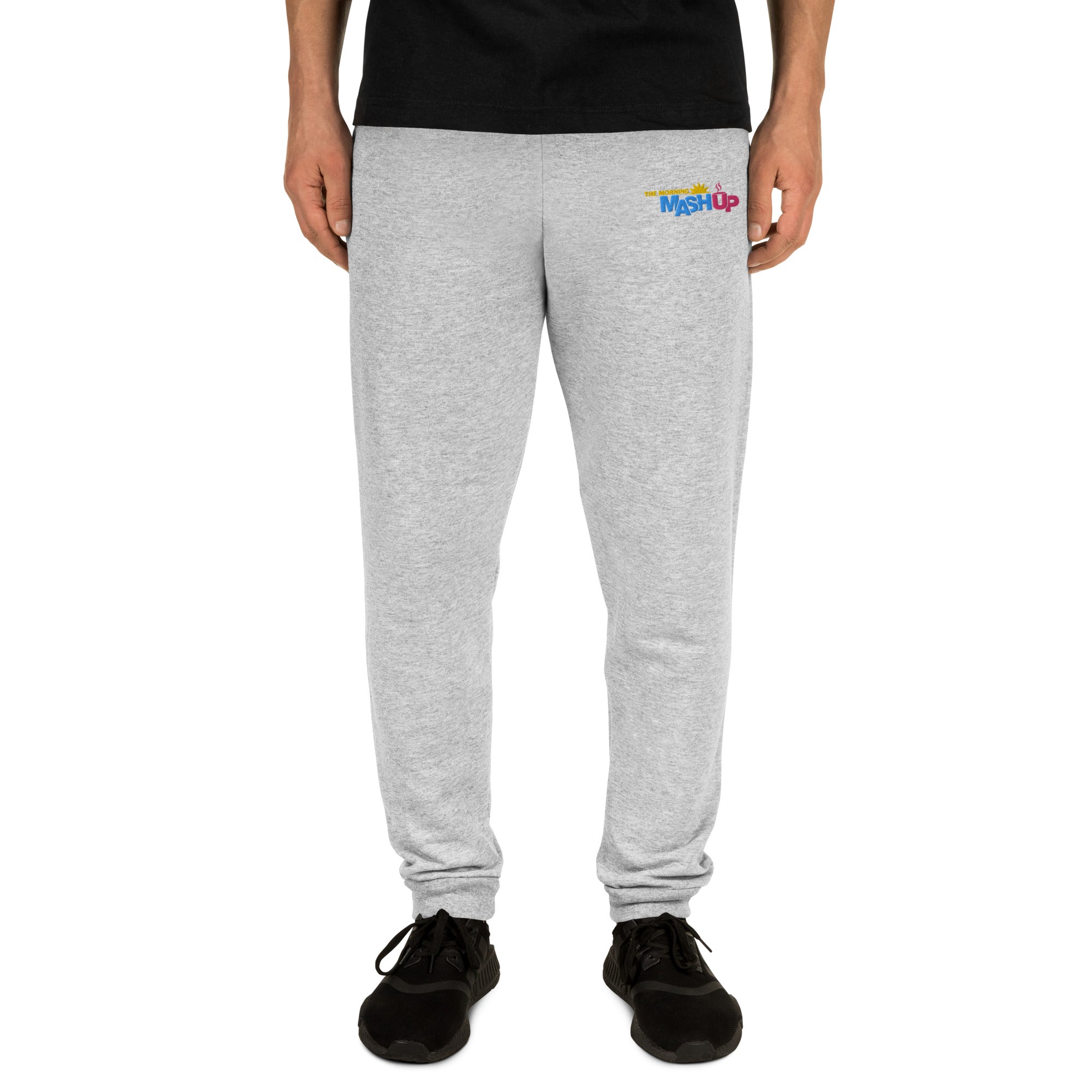 Gray sweatpants with a colorful 'Mash Up' logo on the left thigh, on a model