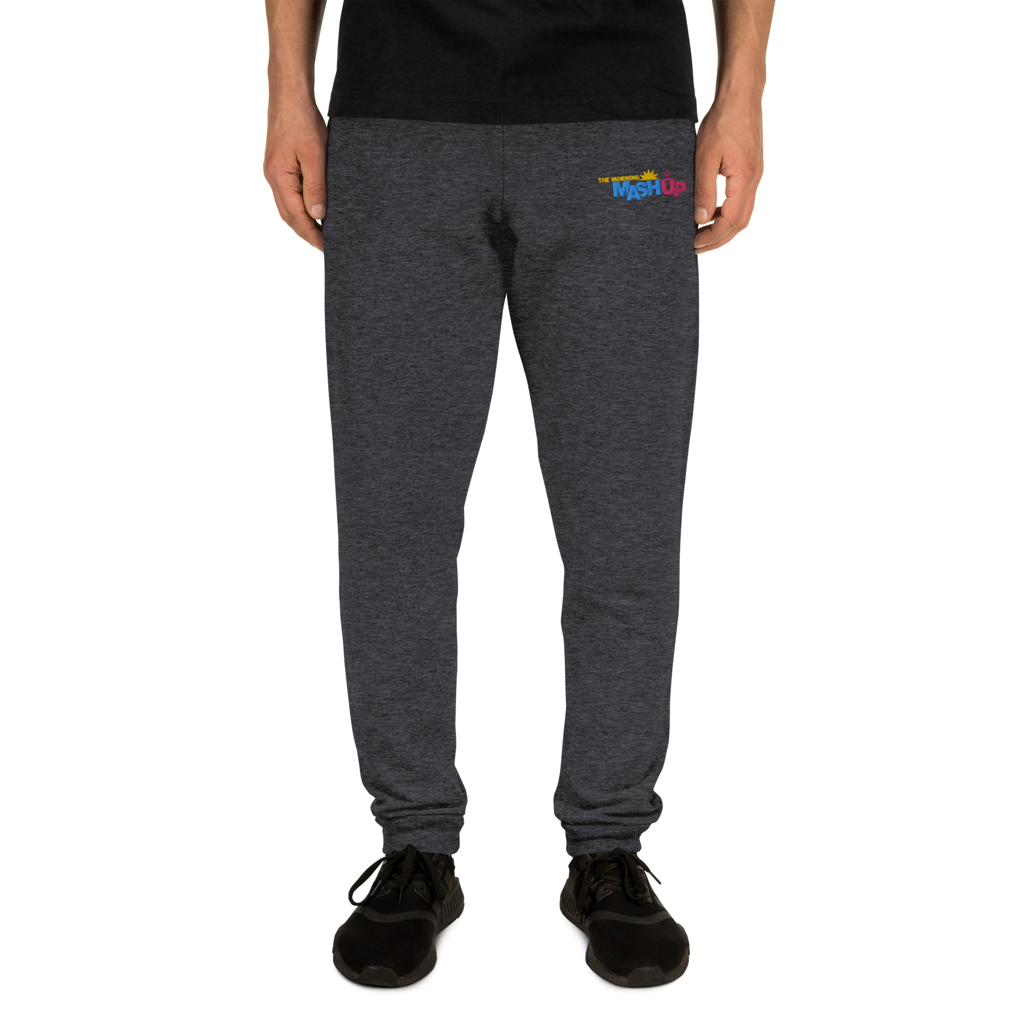 Dark gray sweatpants with a colorful 'Mash Up' logo on the left thigh, on model.