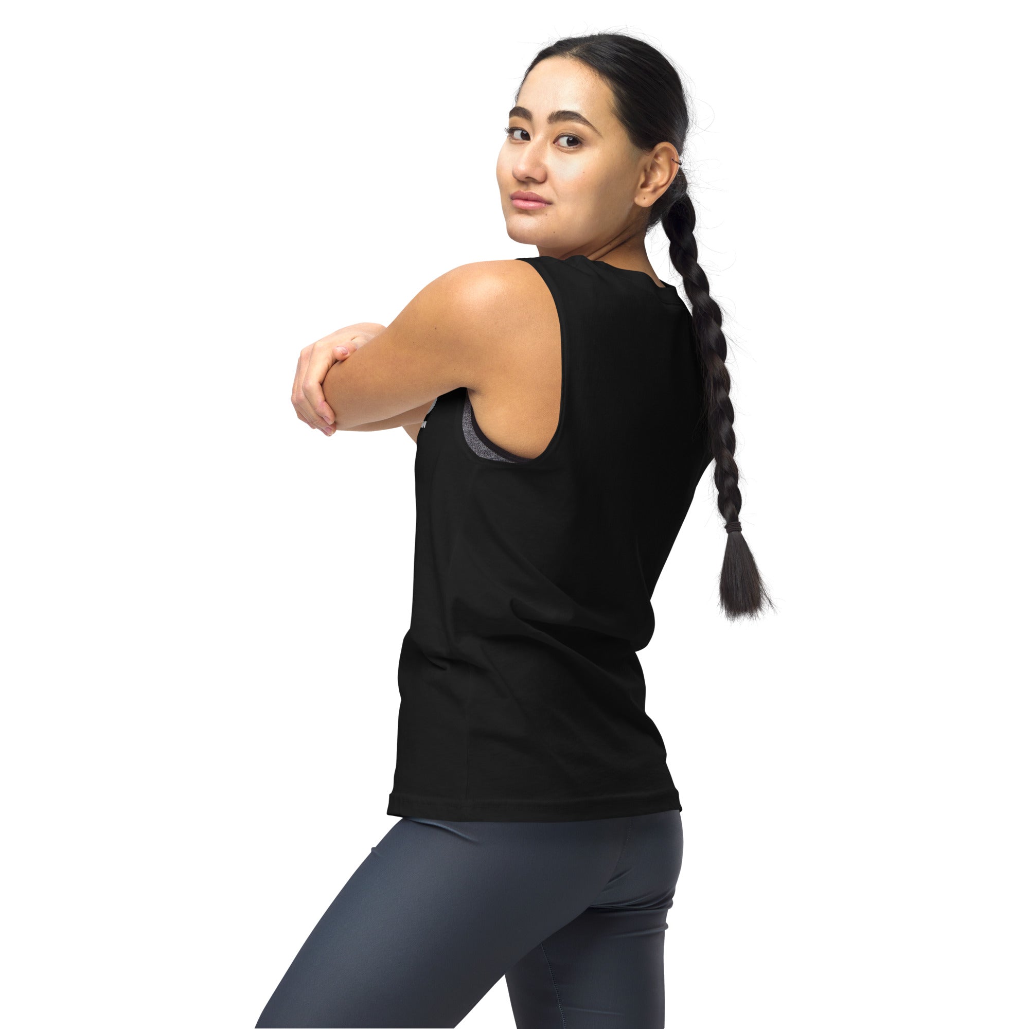 A woman wearing the black SiriusXM muscle tank, viewed from the back-left angle while stretching. The wide armholes reveal a sports bra underneath, and the fit is comfortable for active wear.