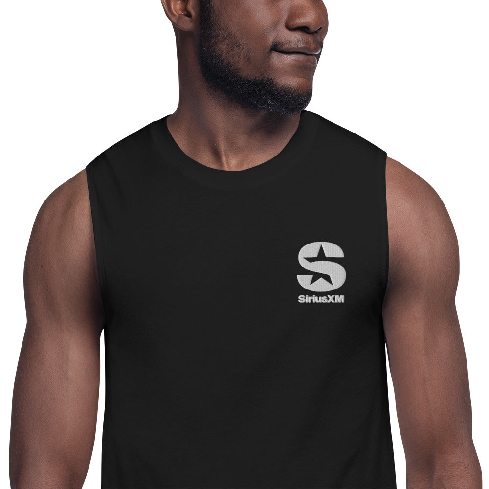 A close-up view of a person wearing a 'SiriusXM' muscle tank, highlighting the white, embroidered logo on the upper left chest. The sleeveless design showcases the model's toned arms.