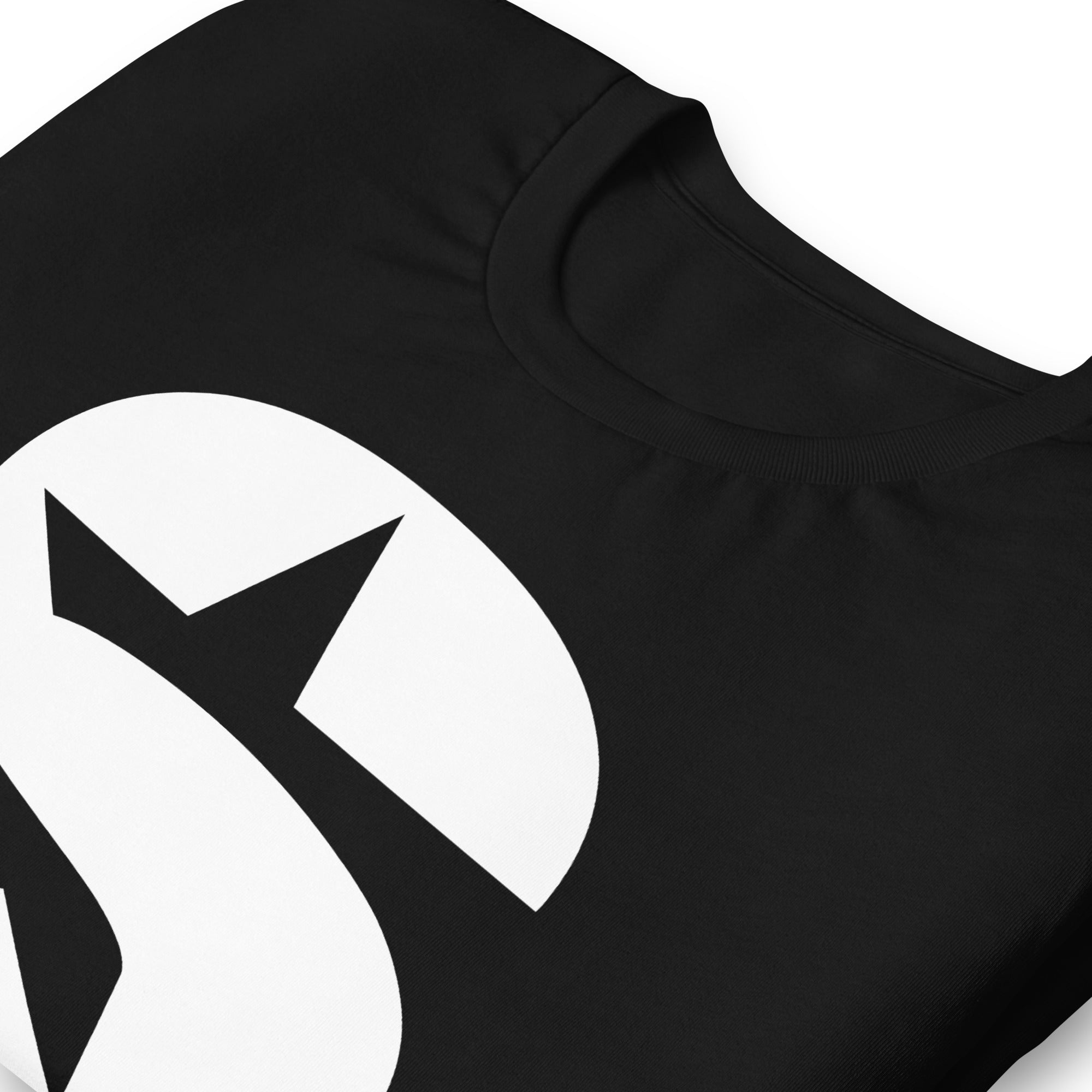 Close-up of a black t-shirt featuring a 'S' logo and stylized letters.