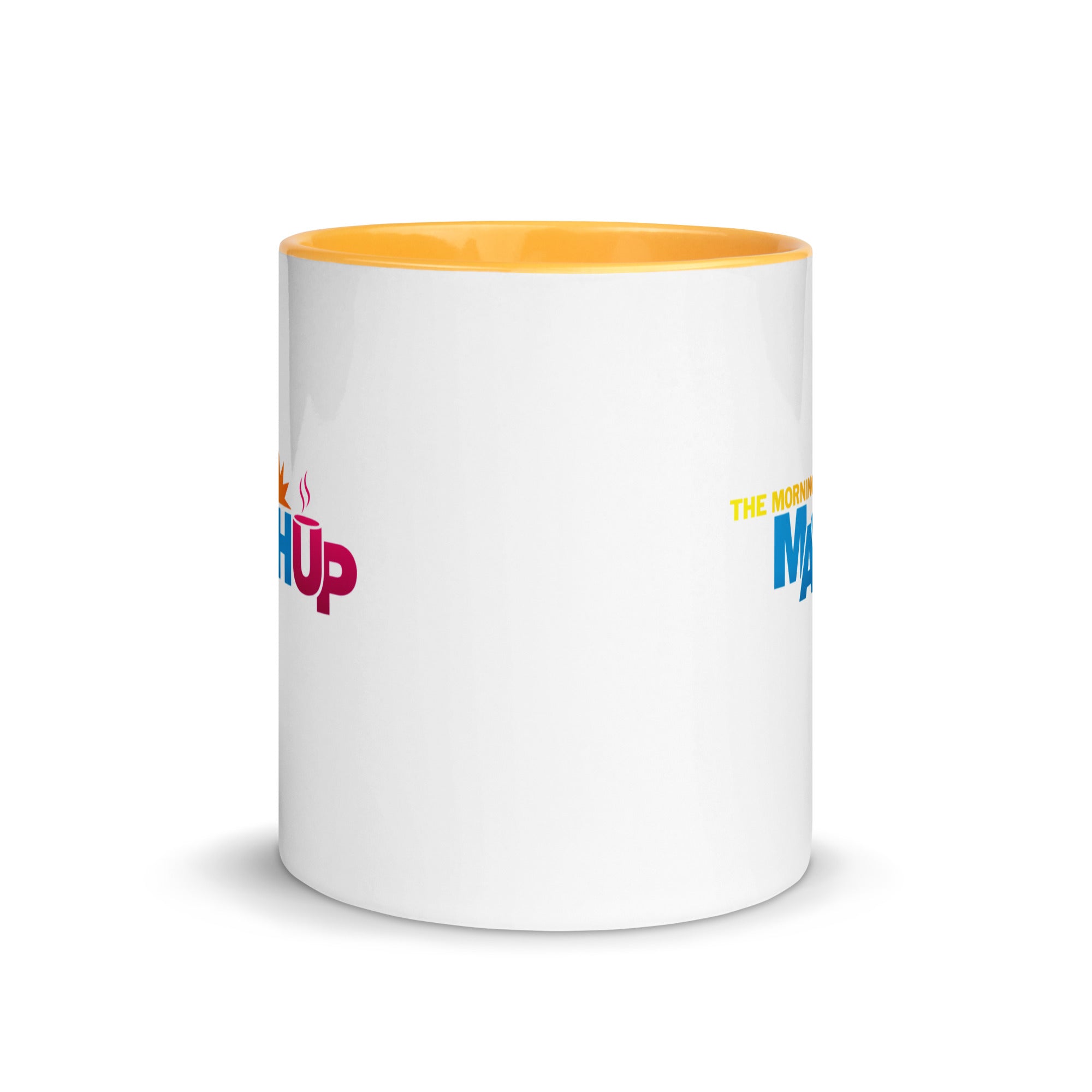 White mug with yellow interior with colorful text on opposite sides.