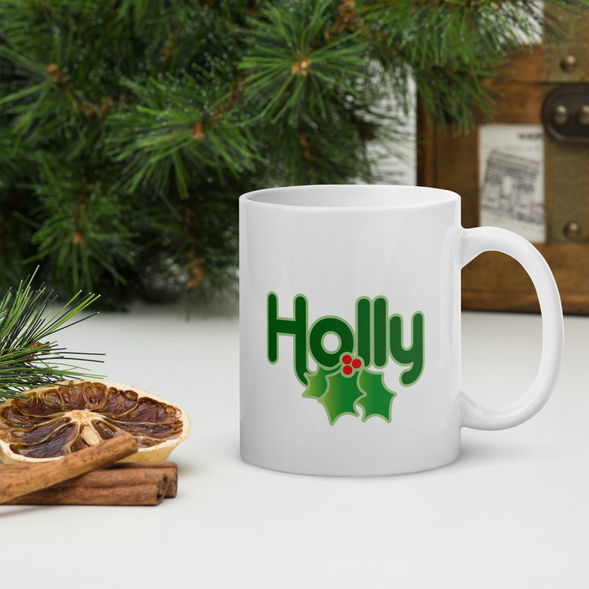 White mug with the word 'Holly' in green letters and a holly decoration