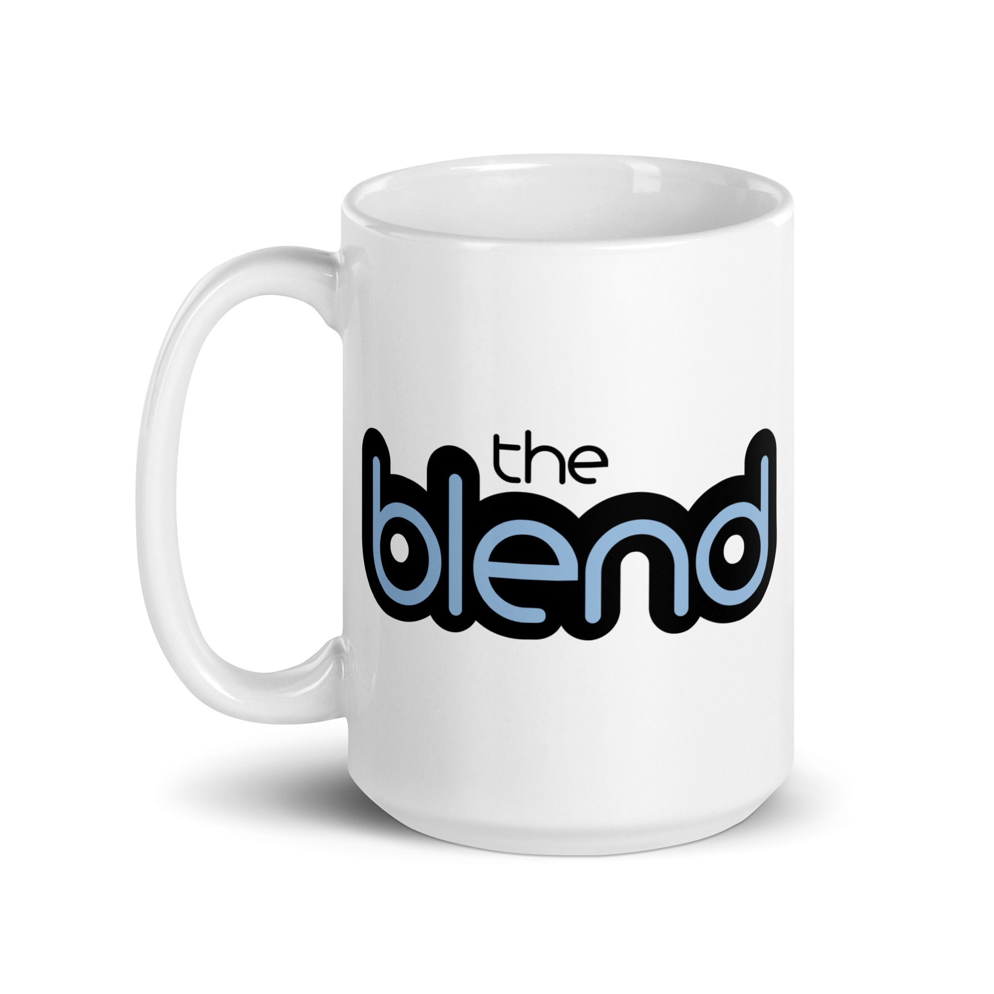 White coffee mug featuring the text 'the blend' in bold black and light blue lettering.