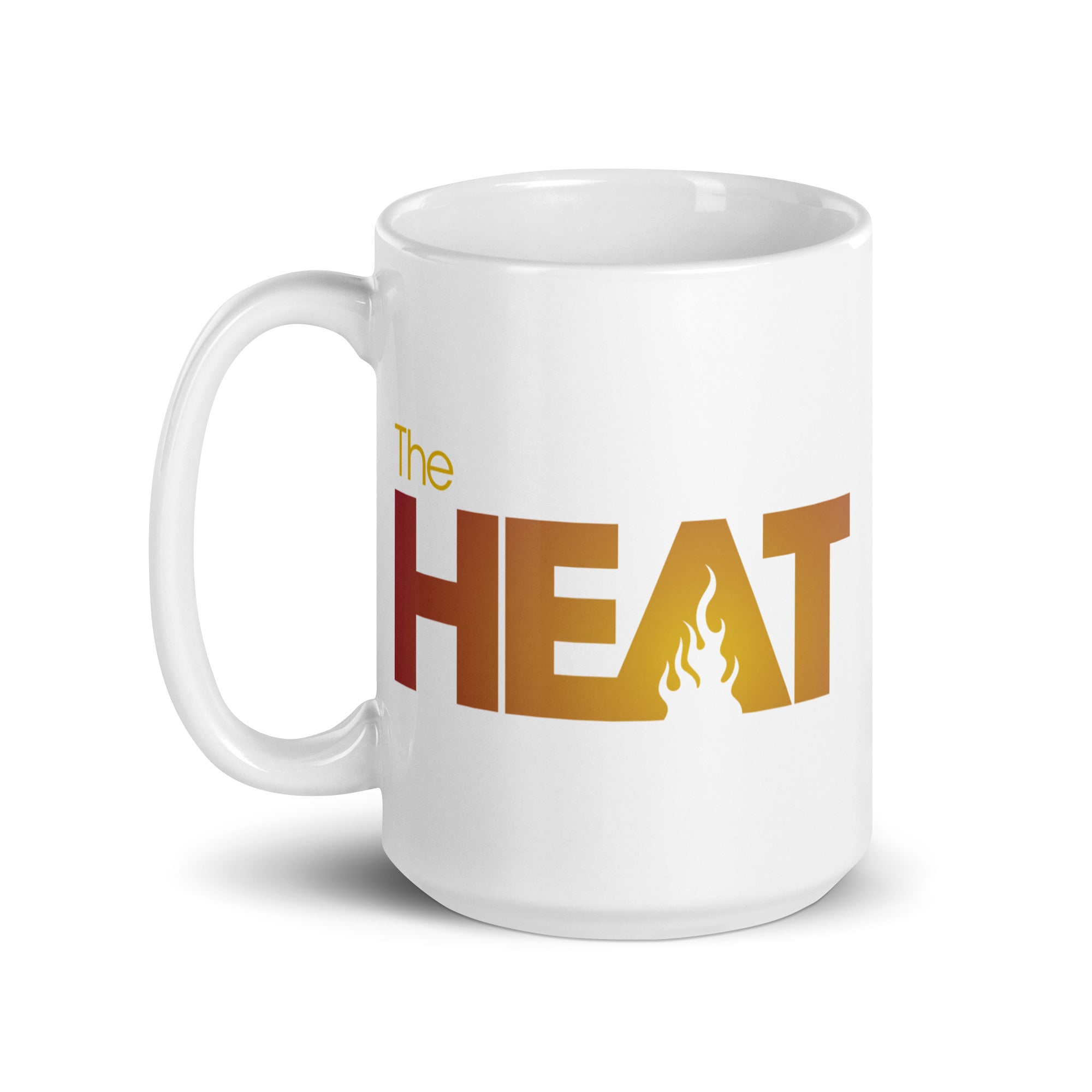 White mug with the text 'The HEAT' in bold orange and yellow letters, featuring a flame symbol in the center.