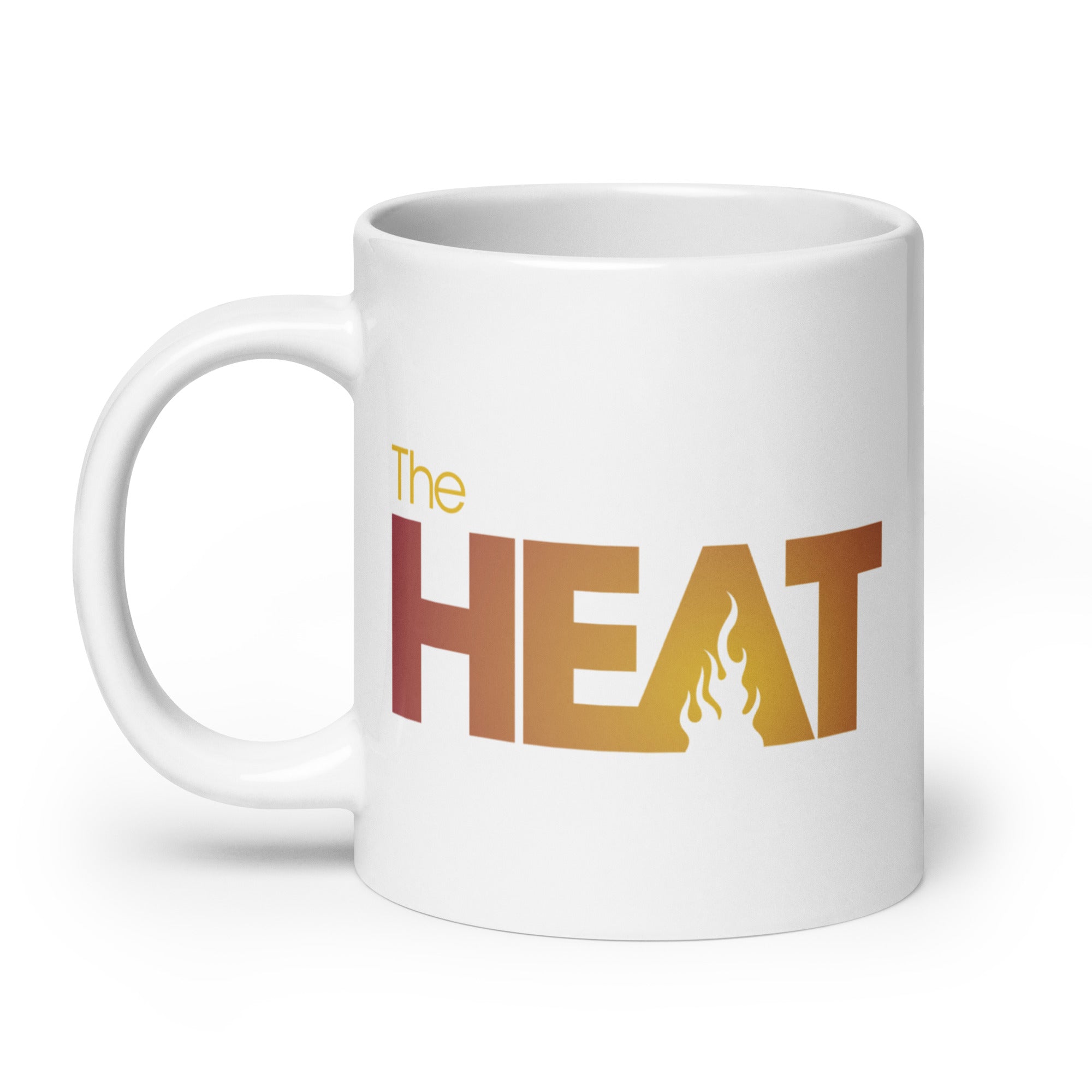 White mug with 'The HEAT' in bold orange to yellow gradient text and a flame graphic.