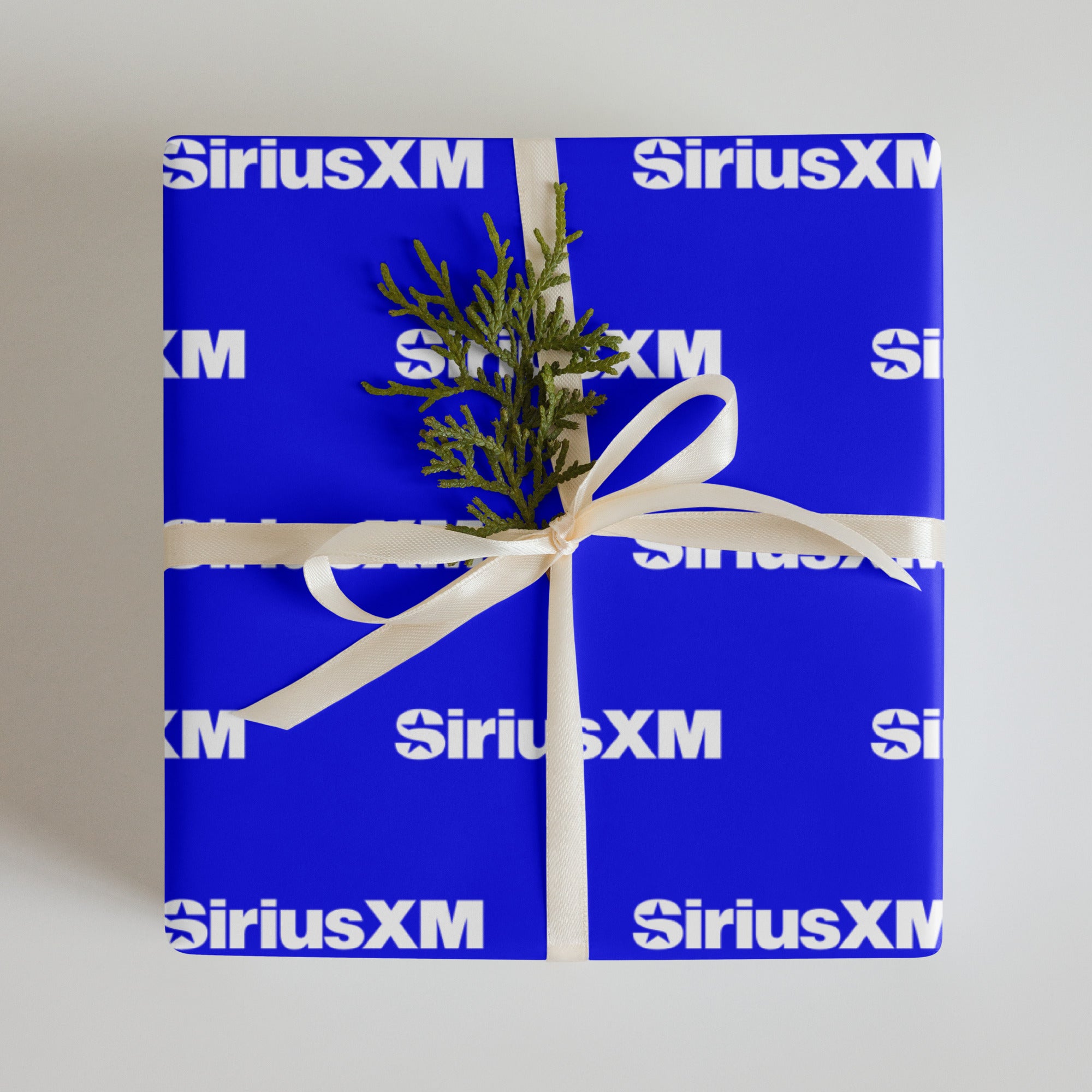 Gift in blue wrapping paper featuring 'SiriusXM' branding.